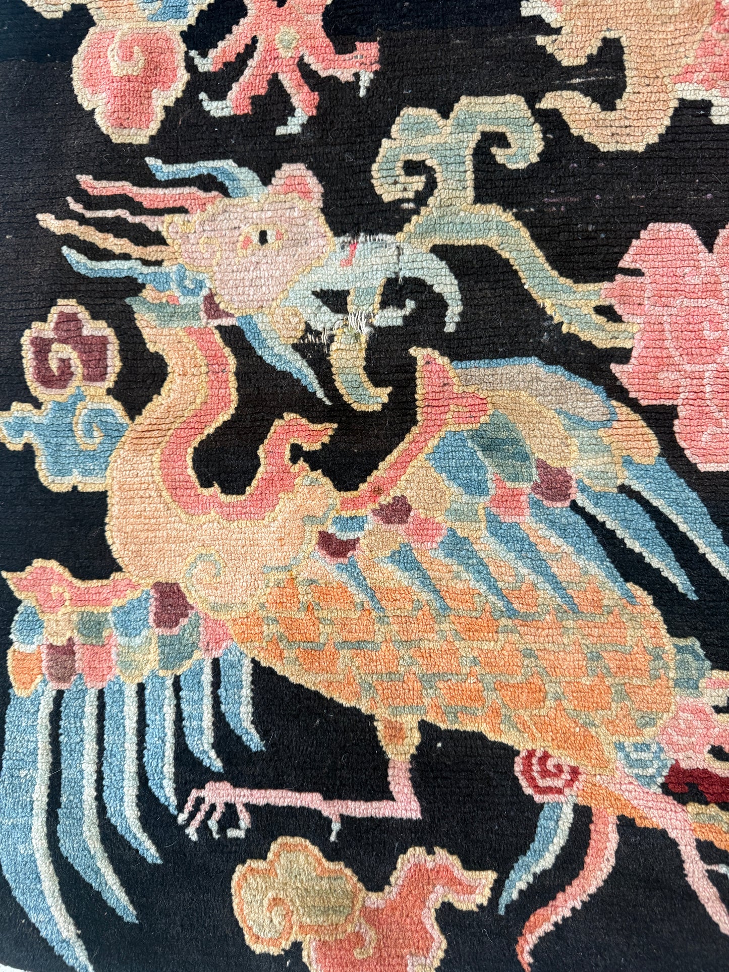 A mid 20th C., Tibetan dragon and phoenix rug