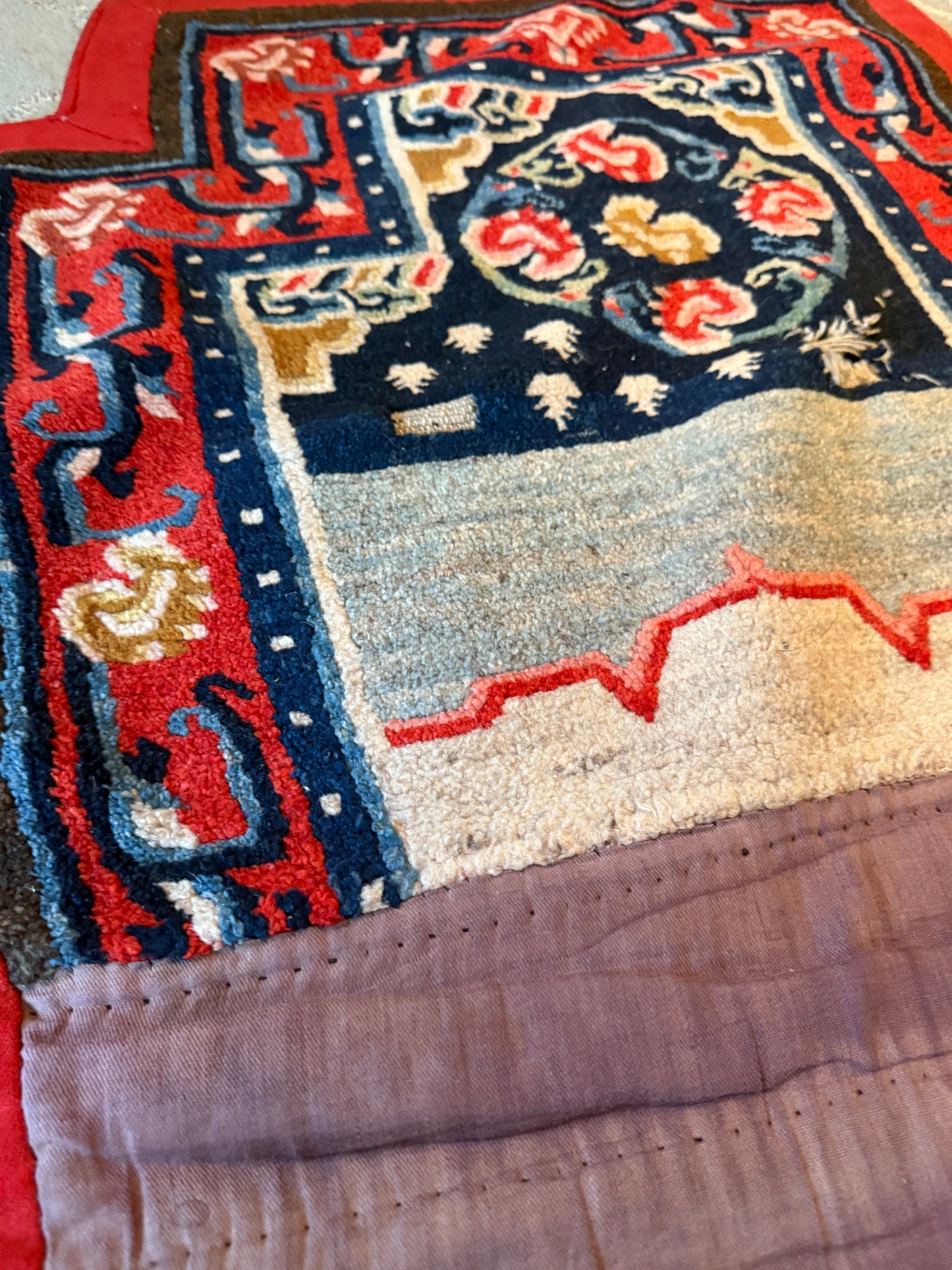 An antique Tibetan saddle rug and rug topper set