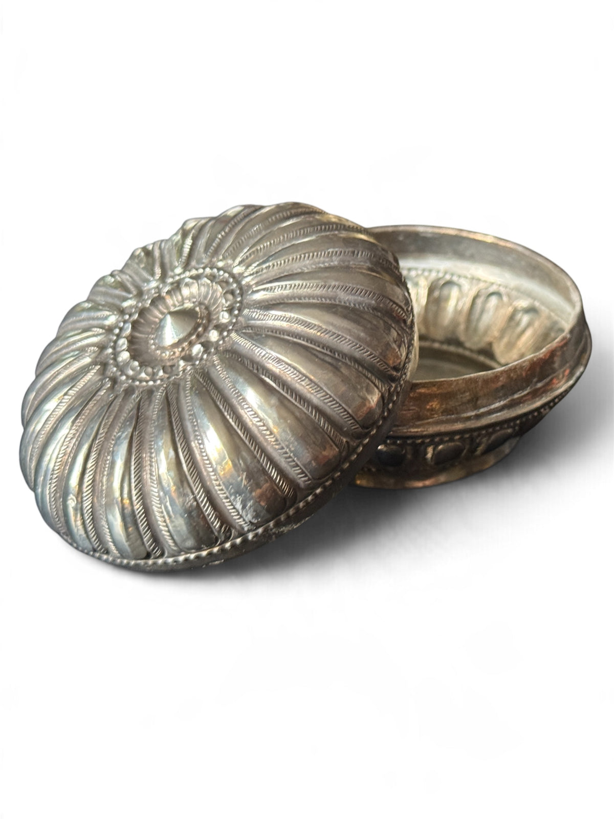An antique silver south East Asian round box with lid