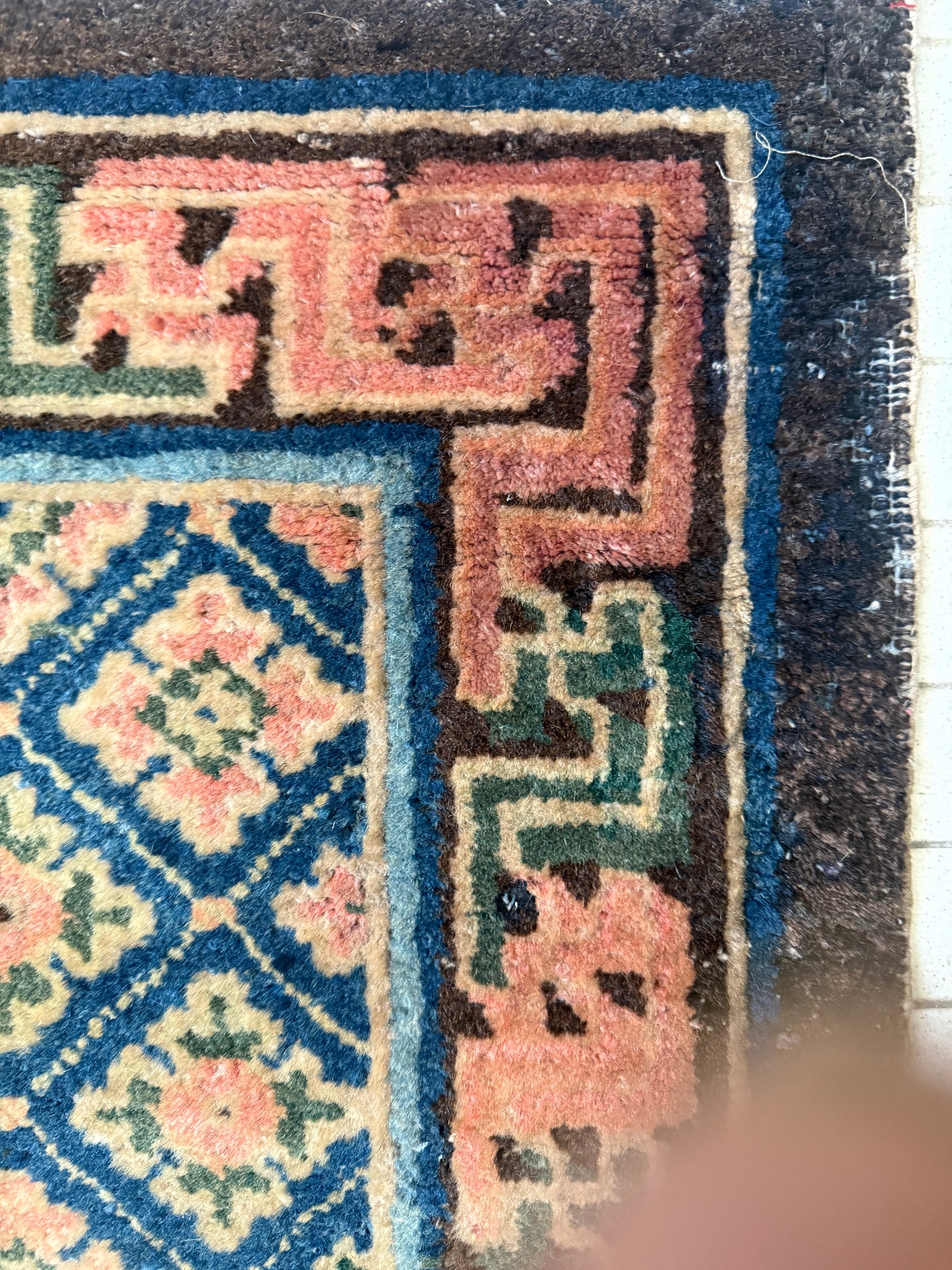 Antique rug with floral motifs arranged in a geometrical design