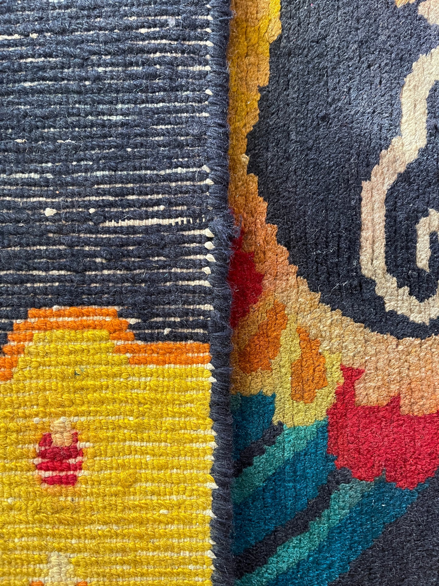 A vintage Tibetan rug featuring a dragon and phoenix