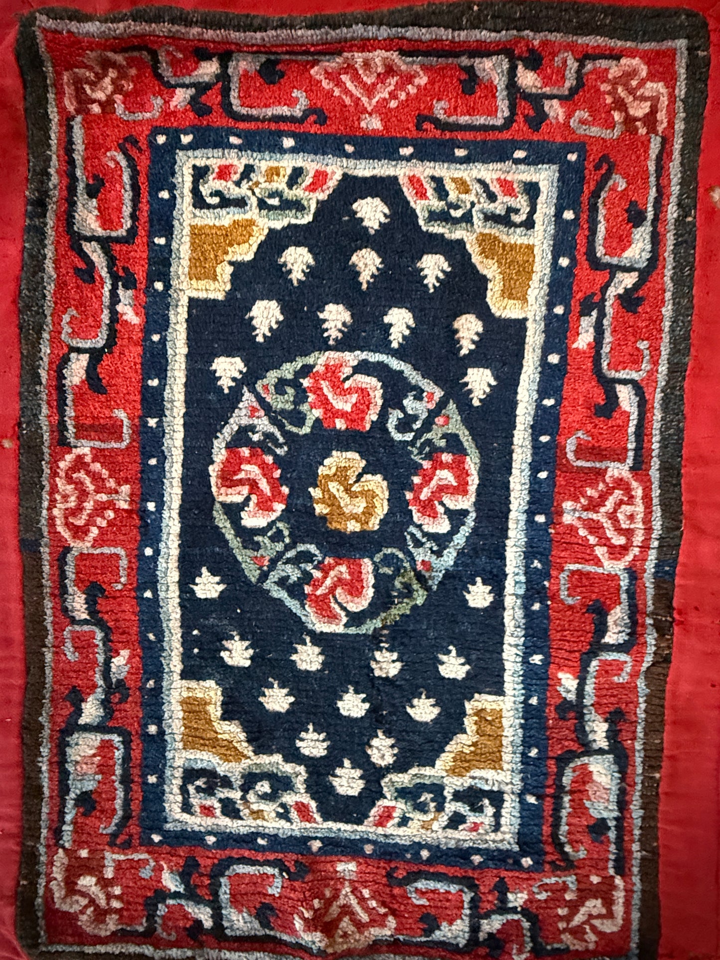 An antique Tibetan saddle rug and rug topper set