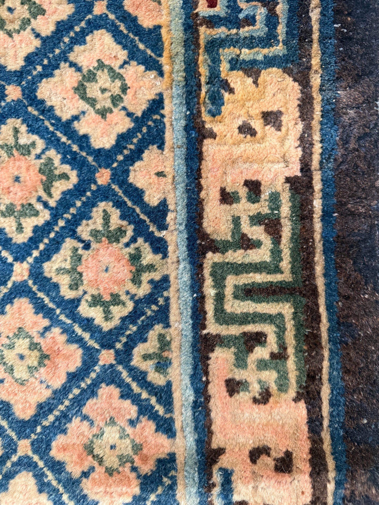 Antique rug with floral motifs arranged in a geometrical design