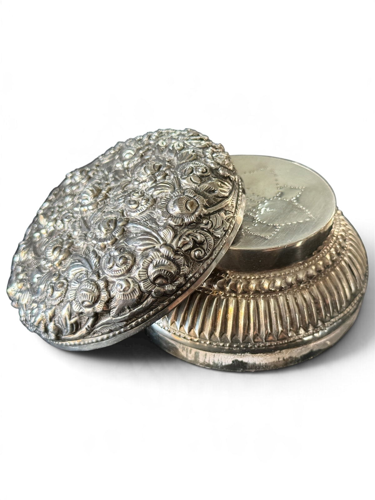 An antique silver south East Asian round box with lid