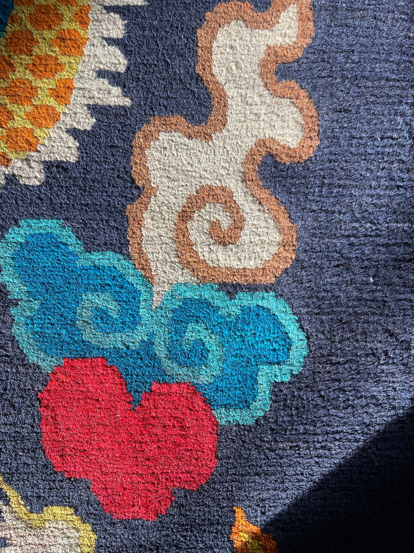 A vintage Tibetan rug featuring a dragon and phoenix