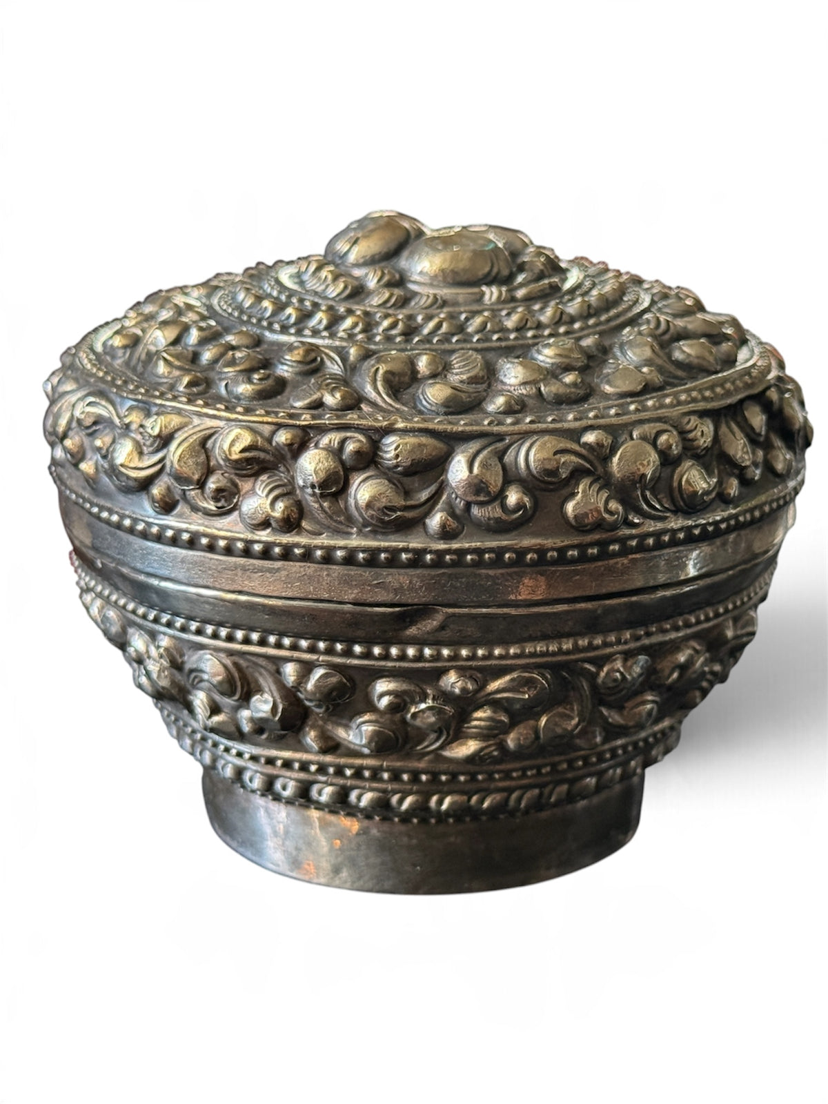 An antique silver south East Asian round box with lid