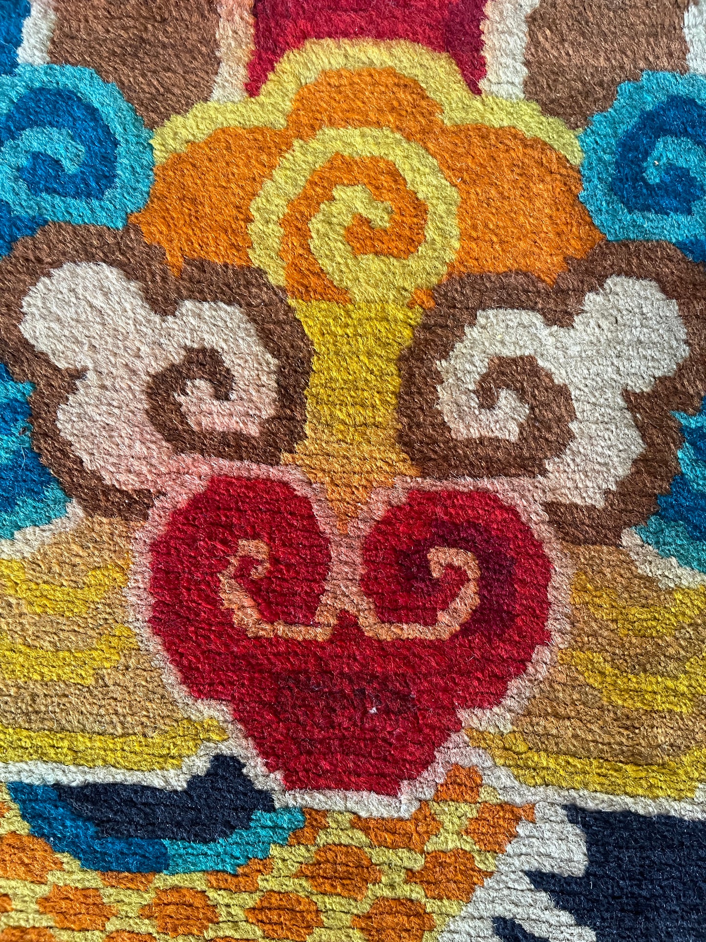 A vintage Tibetan rug featuring a dragon and phoenix