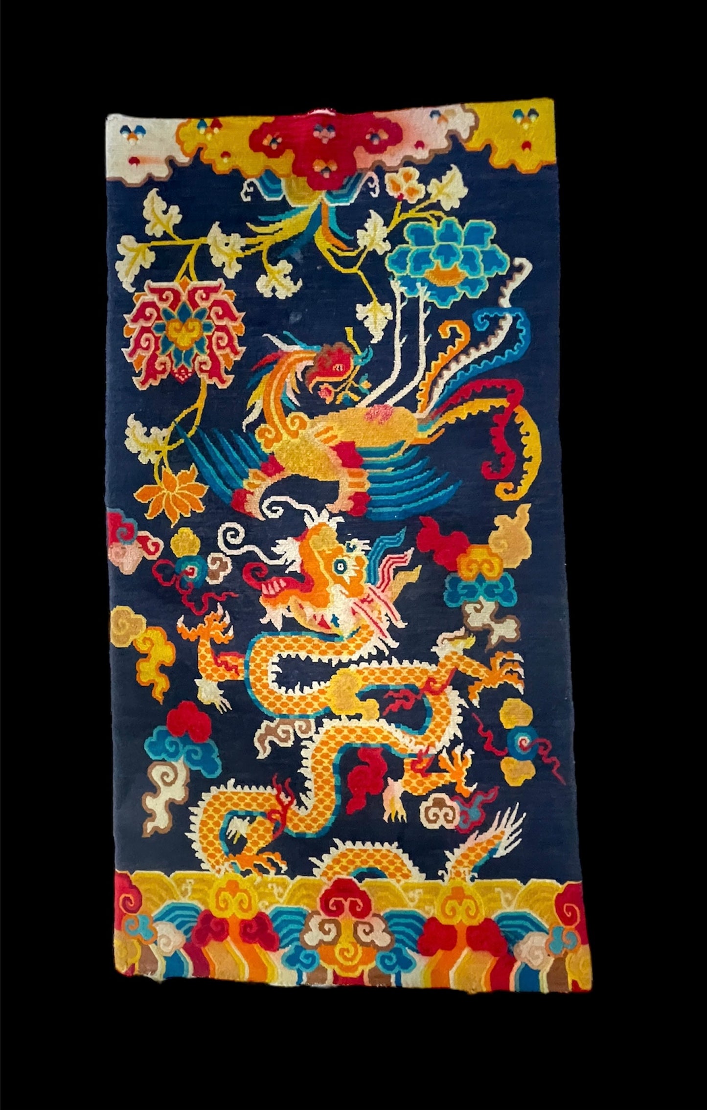 A vintage Tibetan rug featuring a dragon and phoenix