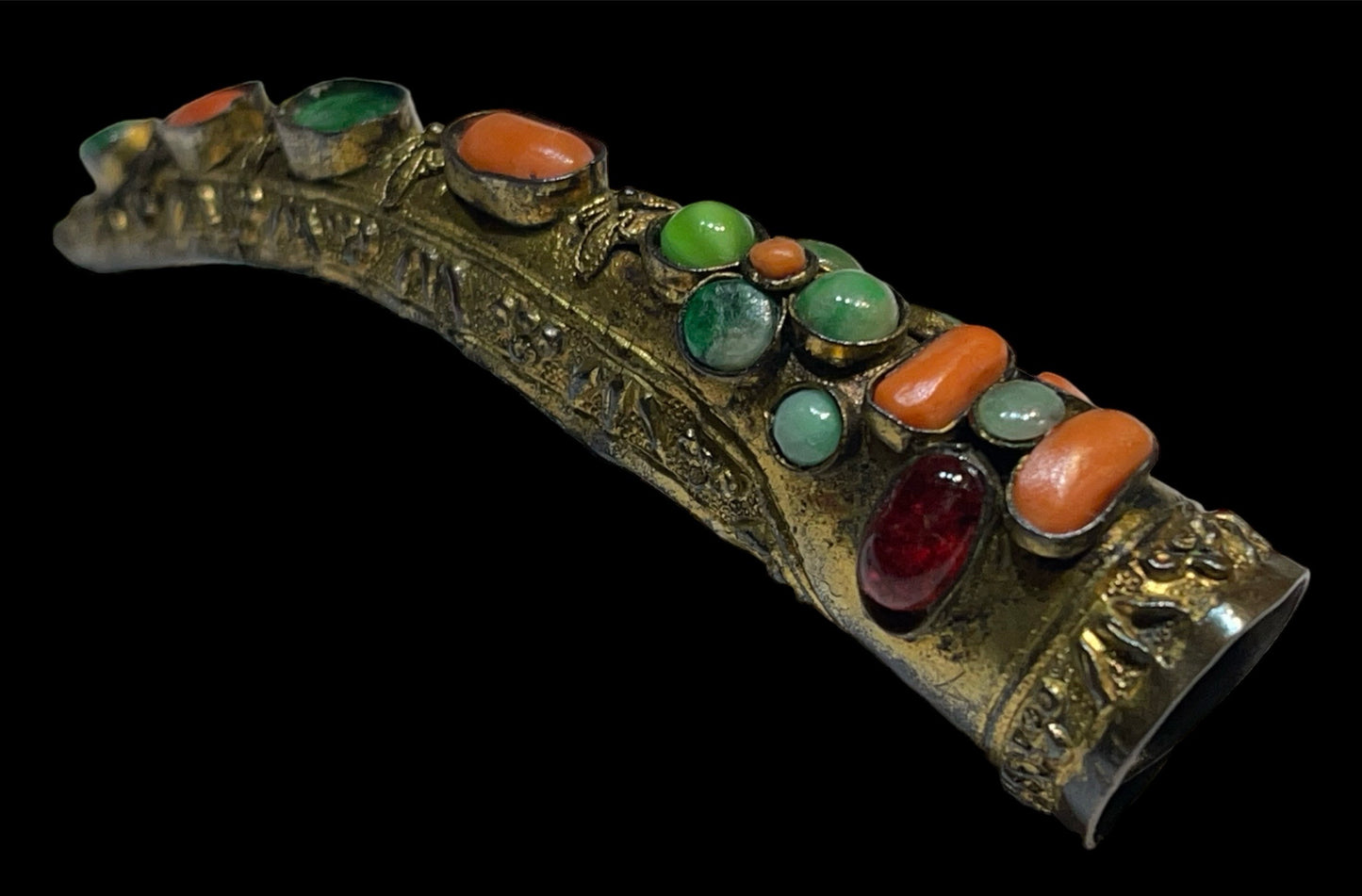 A vintage gilded silver nail cover with intricate carved work
