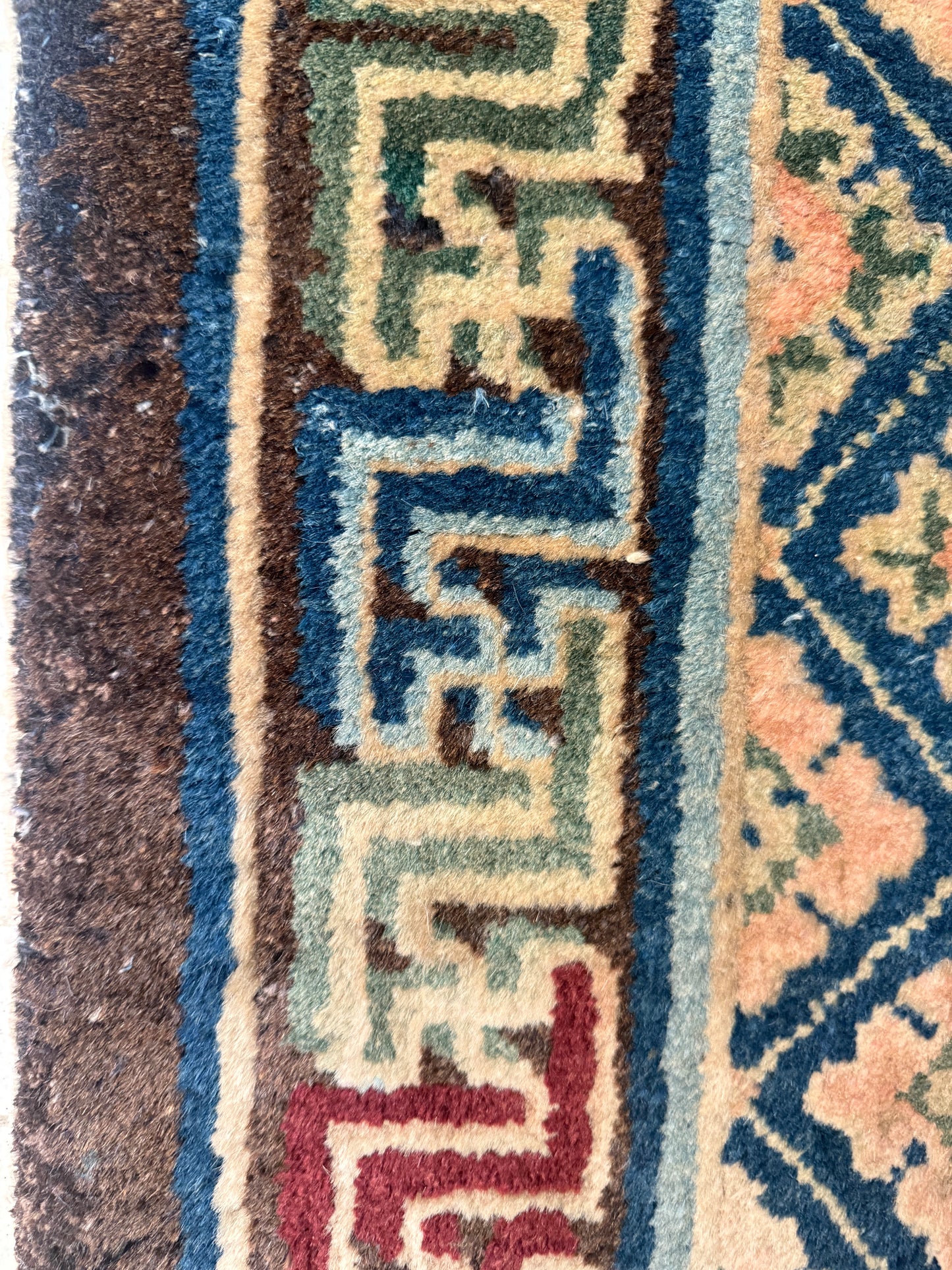 Antique rug with floral motifs arranged in a geometrical design