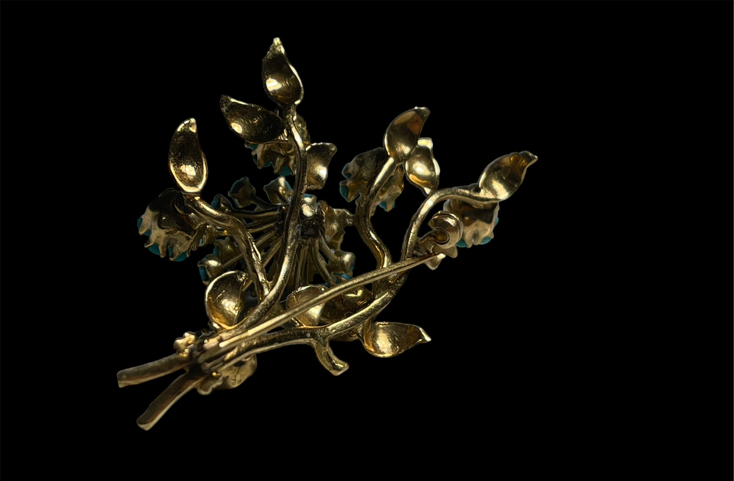 A 14k gold brooch with turquoise and ruby stones