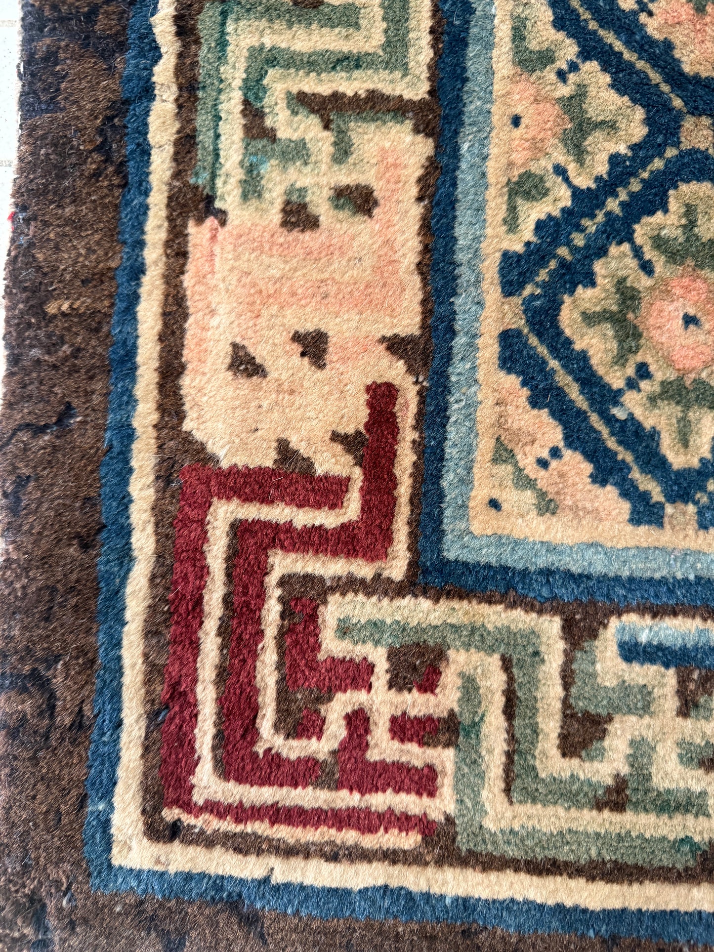 Antique rug with floral motifs arranged in a geometrical design