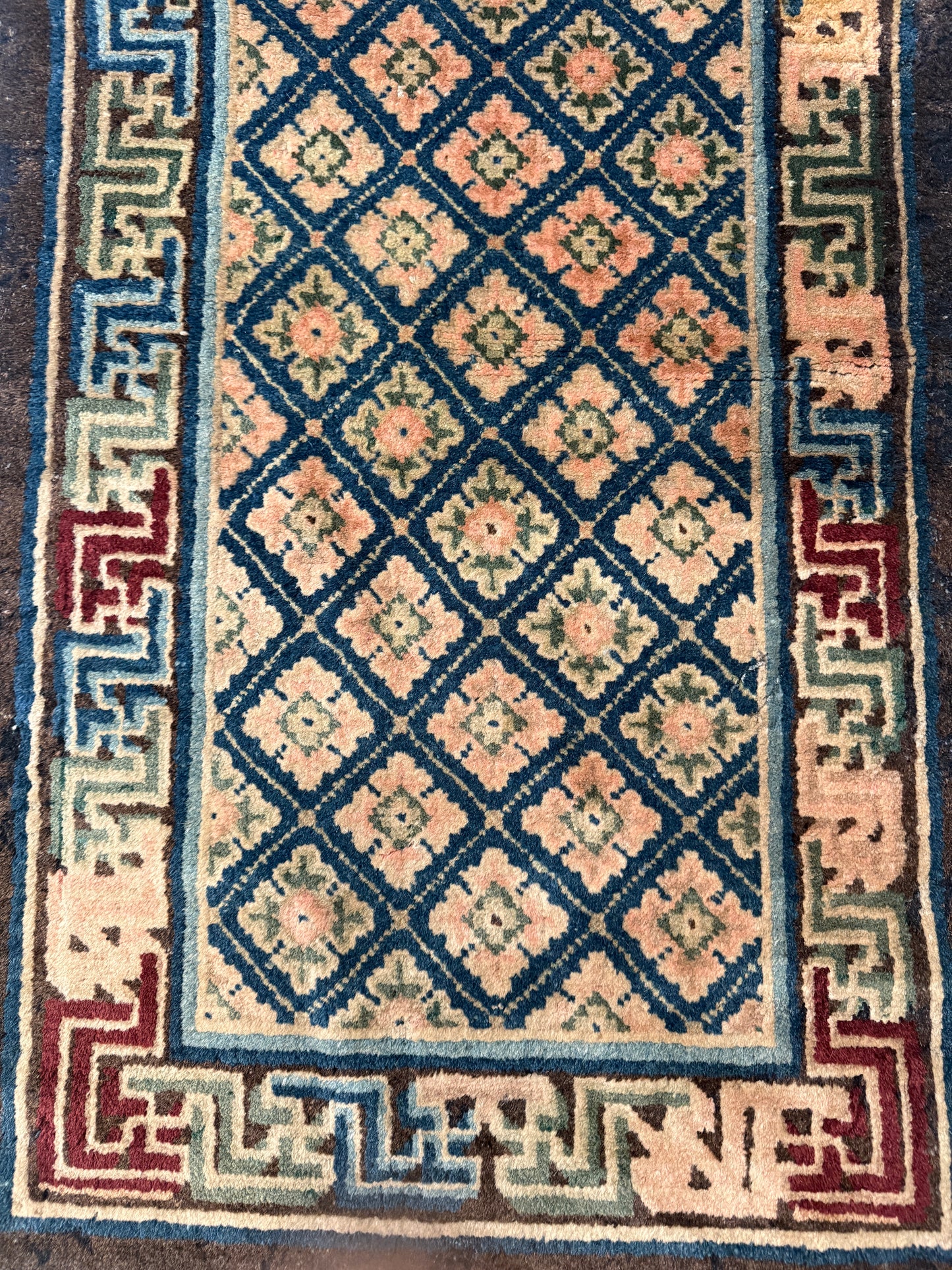 Antique rug with floral motifs arranged in a geometrical design