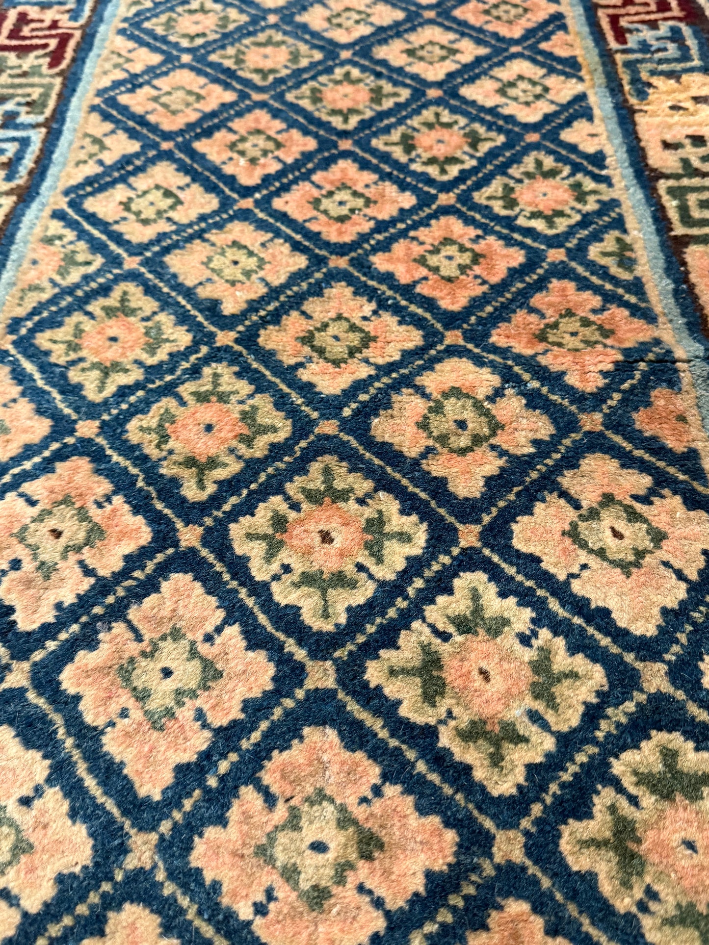 Antique rug with floral motifs arranged in a geometrical design