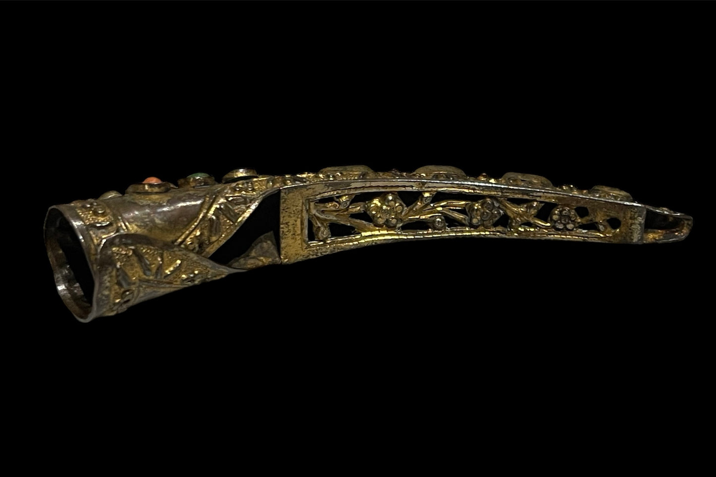 A vintage gilded silver nail cover with intricate carved work