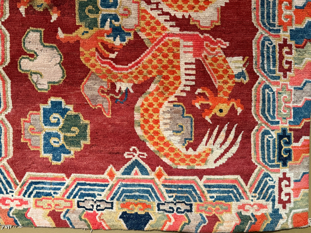 An early 20th C., antique Tibetan dragon rug