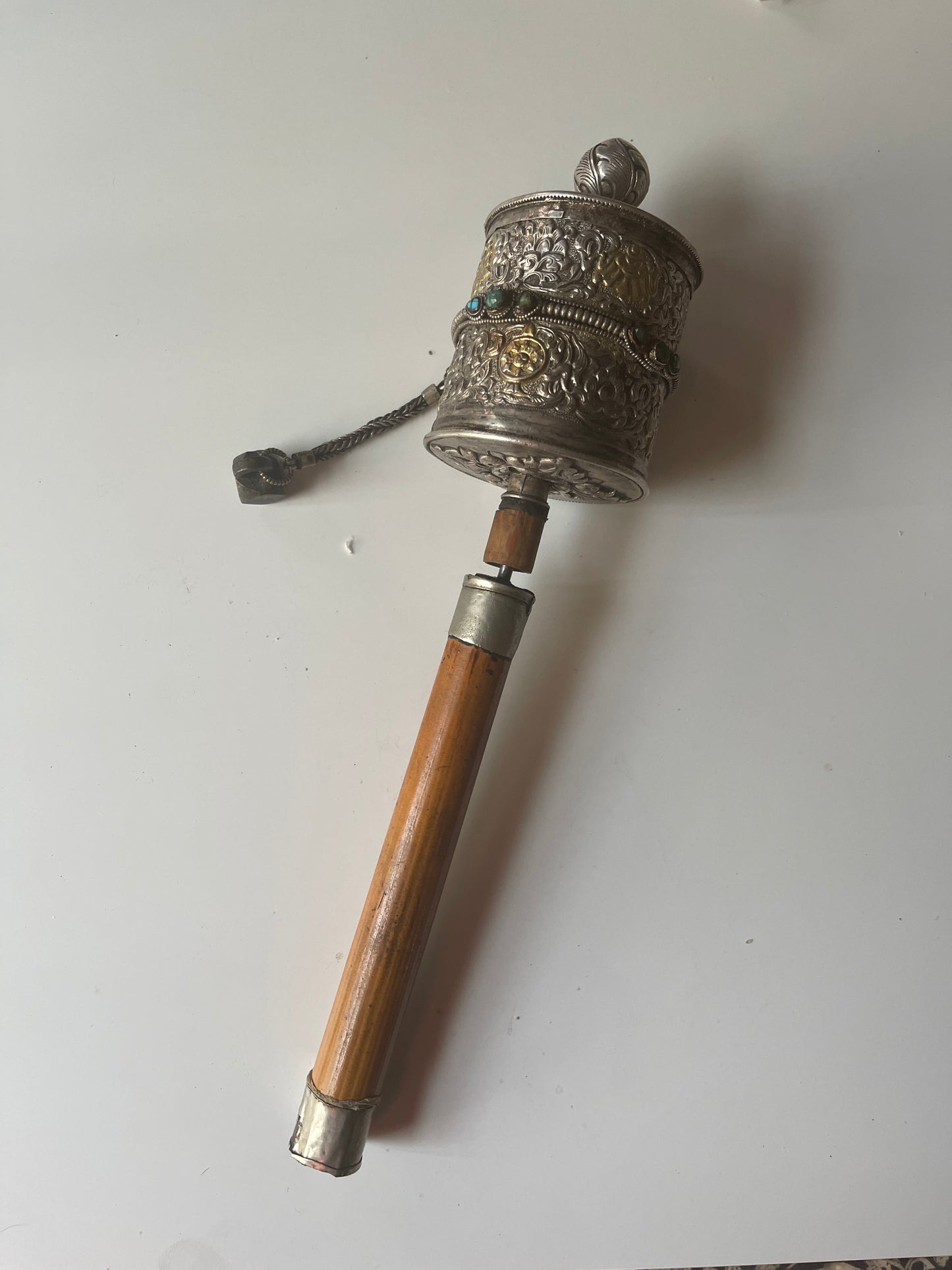 An antique Tibetan handheld prayer wheel