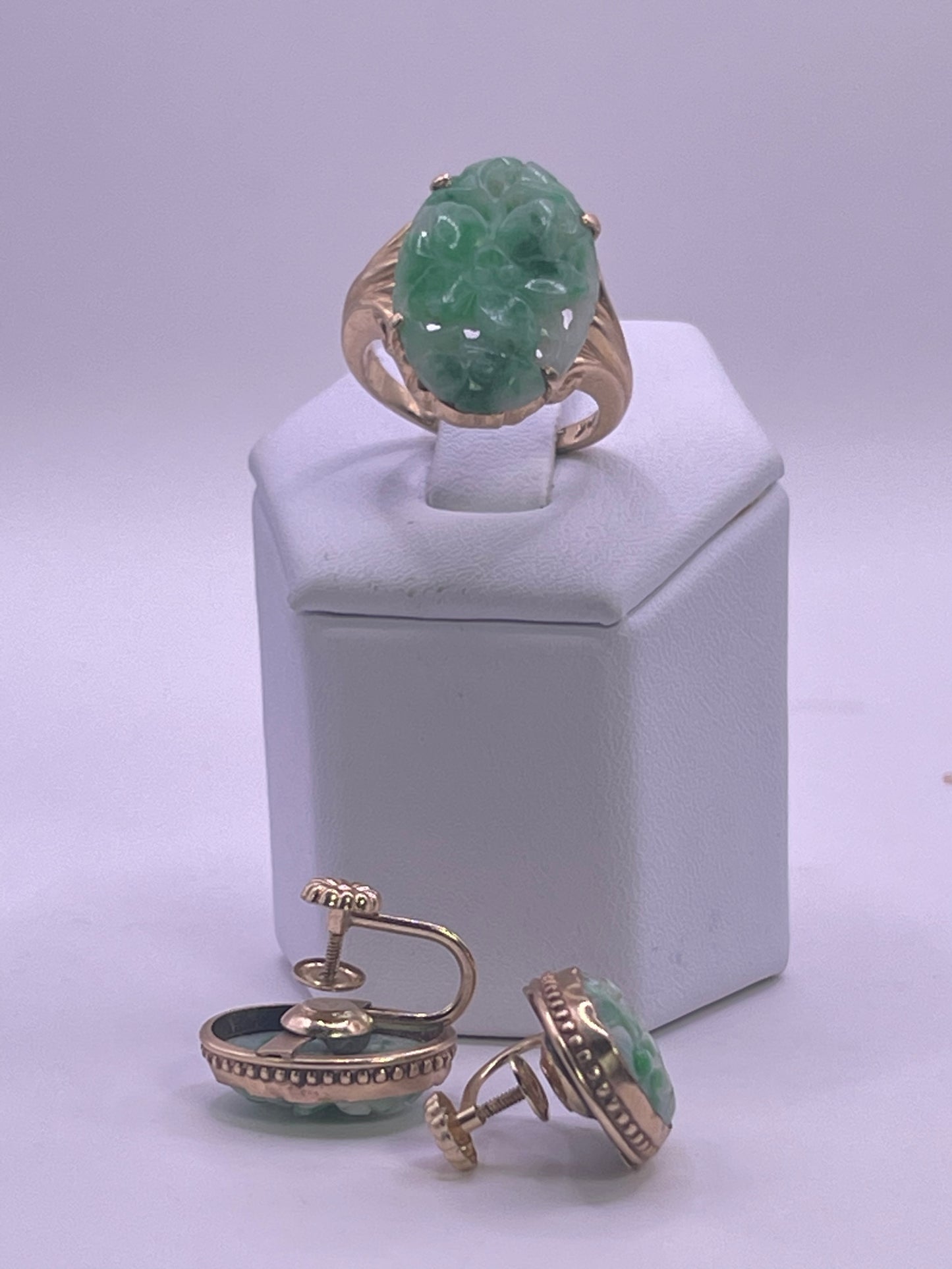 A jade jewelry set is 14kt gold setting