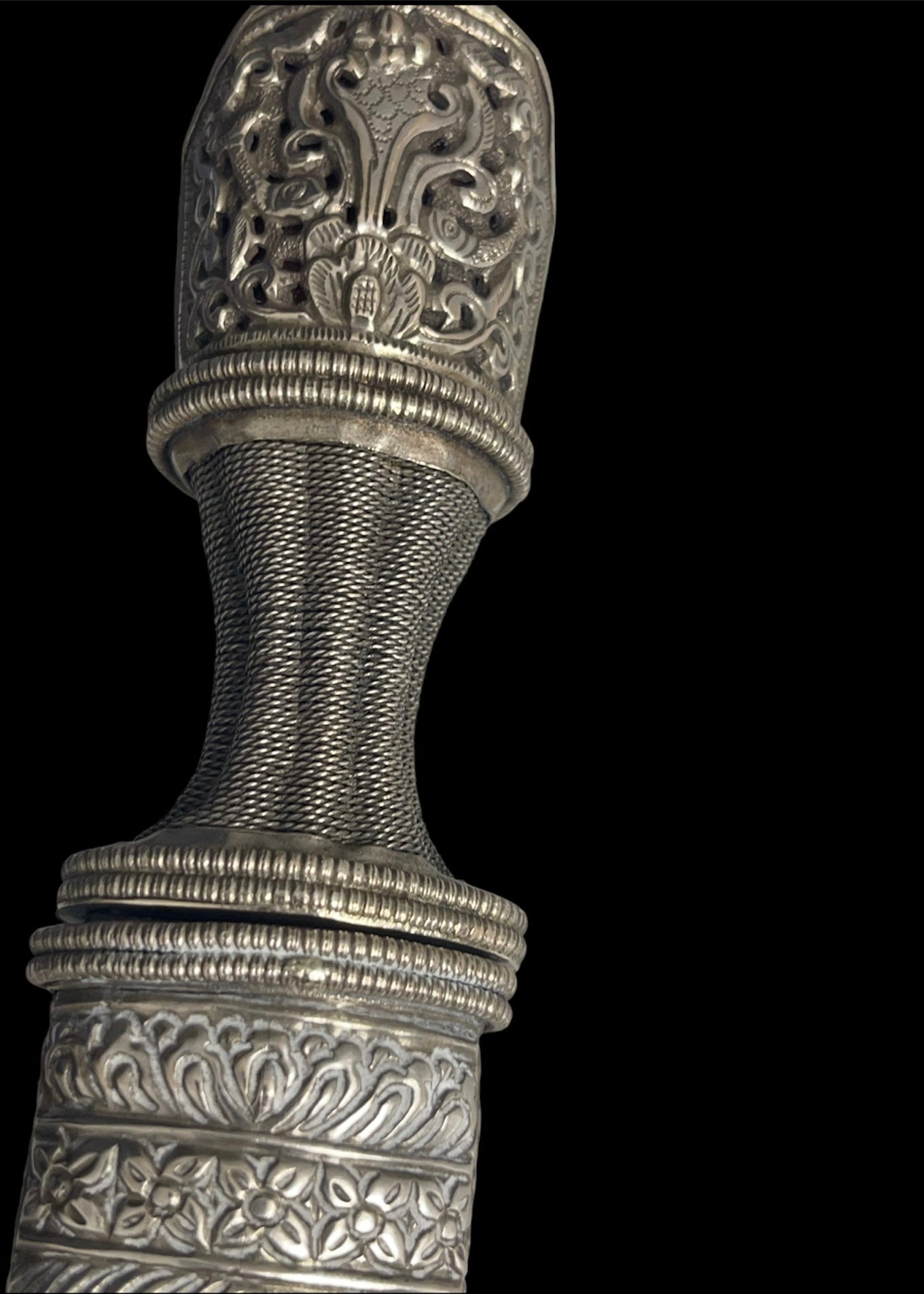 An antique Tibetan dagger with a carved silver sheath