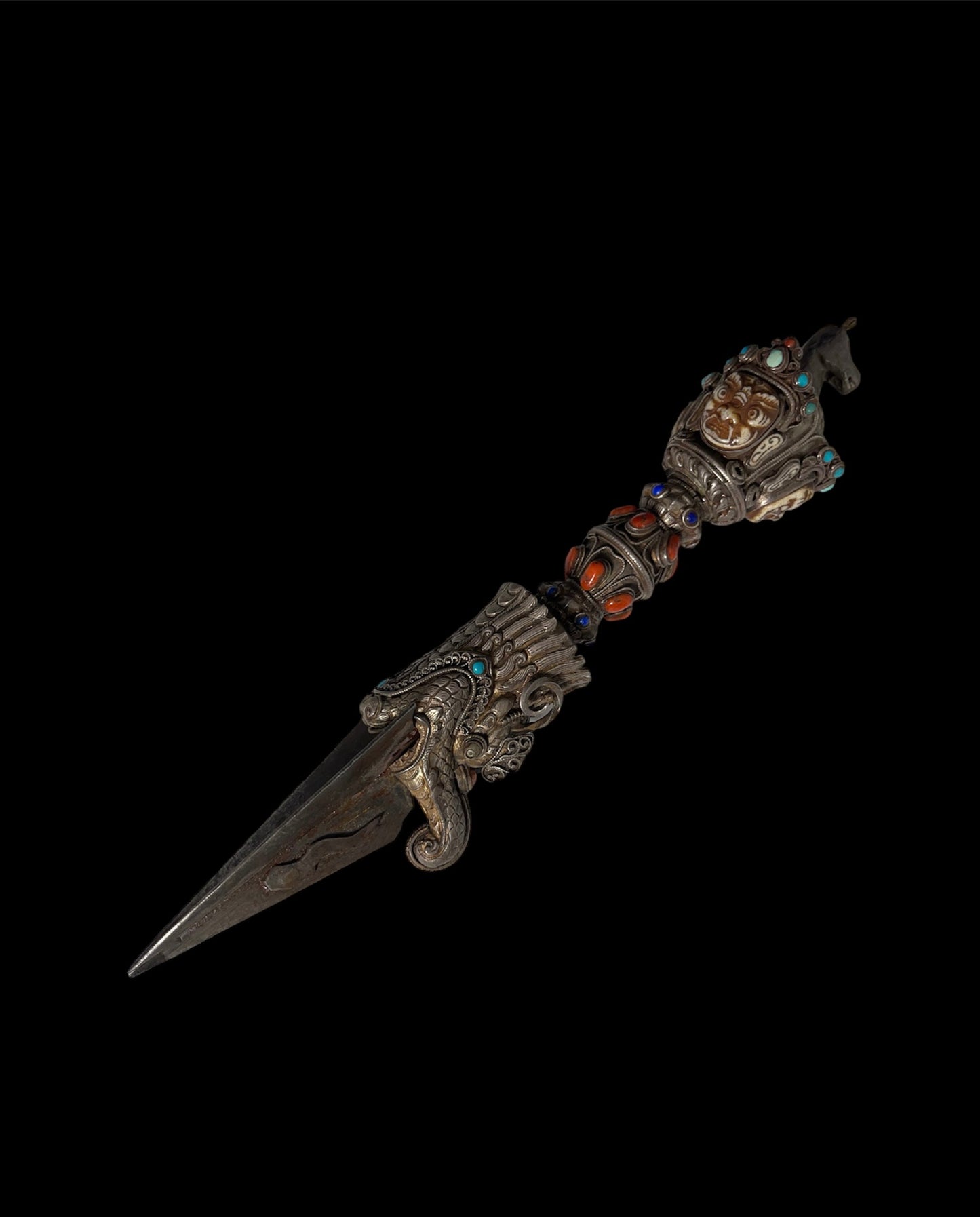 A vintage ceremonial Tibetan dagger in silver and precious stones