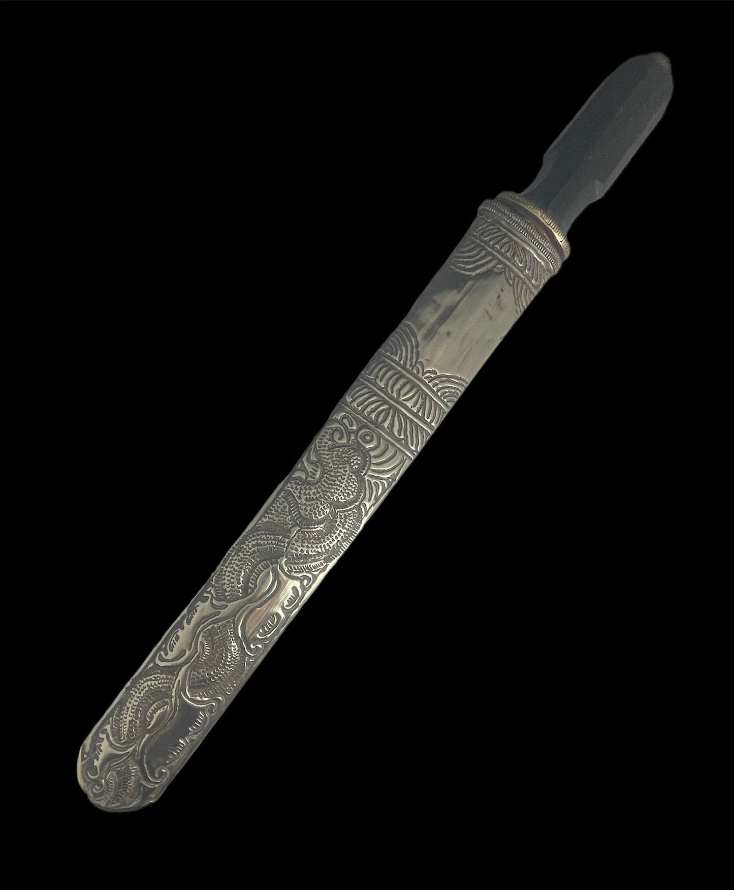 An antique Tibetan dagger with a carved silver sheath