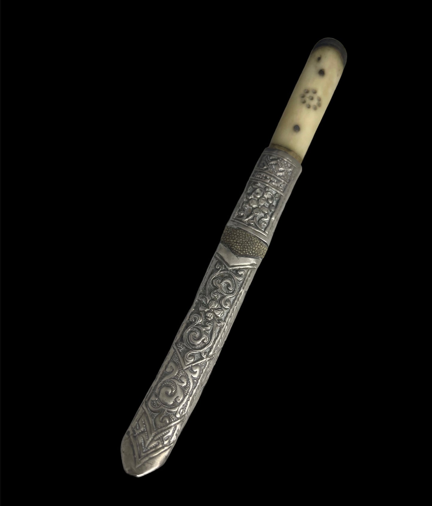 An antique Tibetan dagger with a carved silver sheath