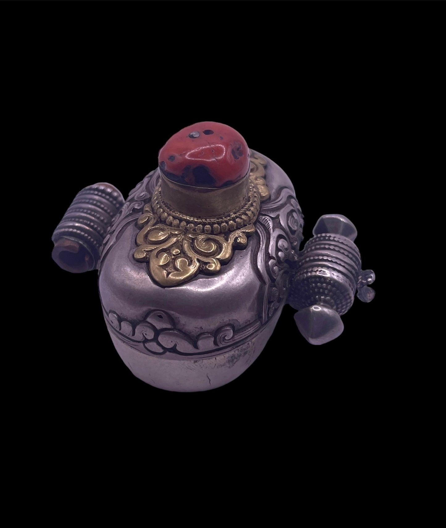 An antique silver and coral ghau amulet
