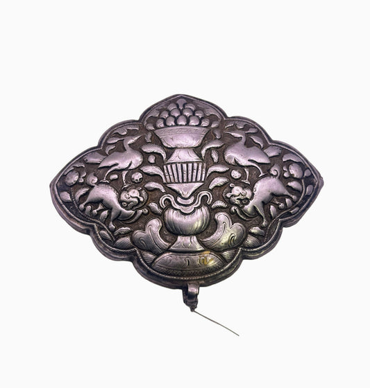 An antique Tibetan silver belt buckle