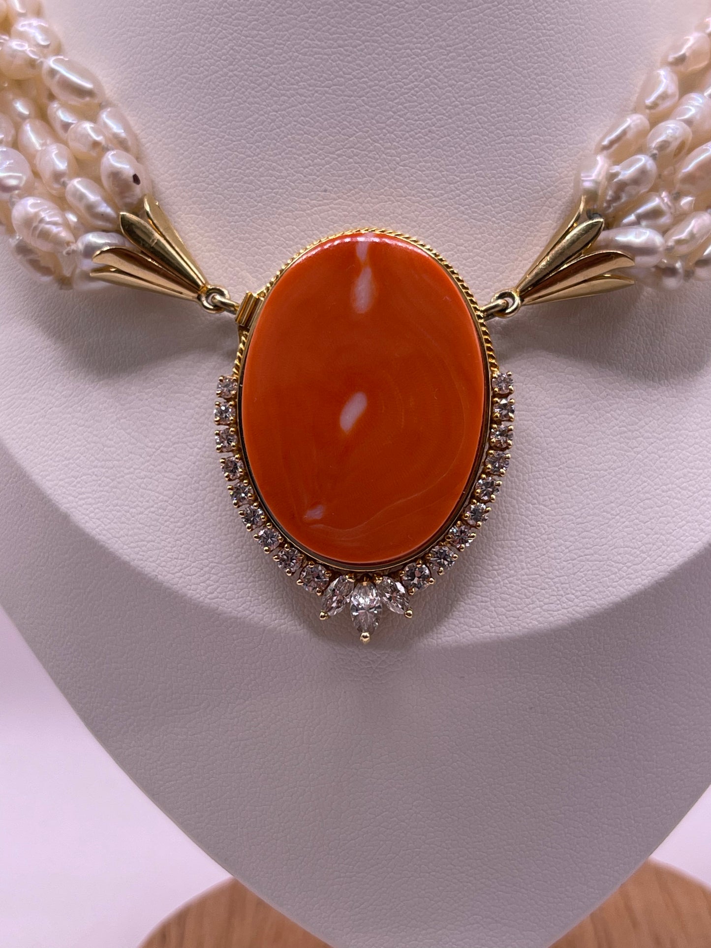 A pearl torsade with coral clasp