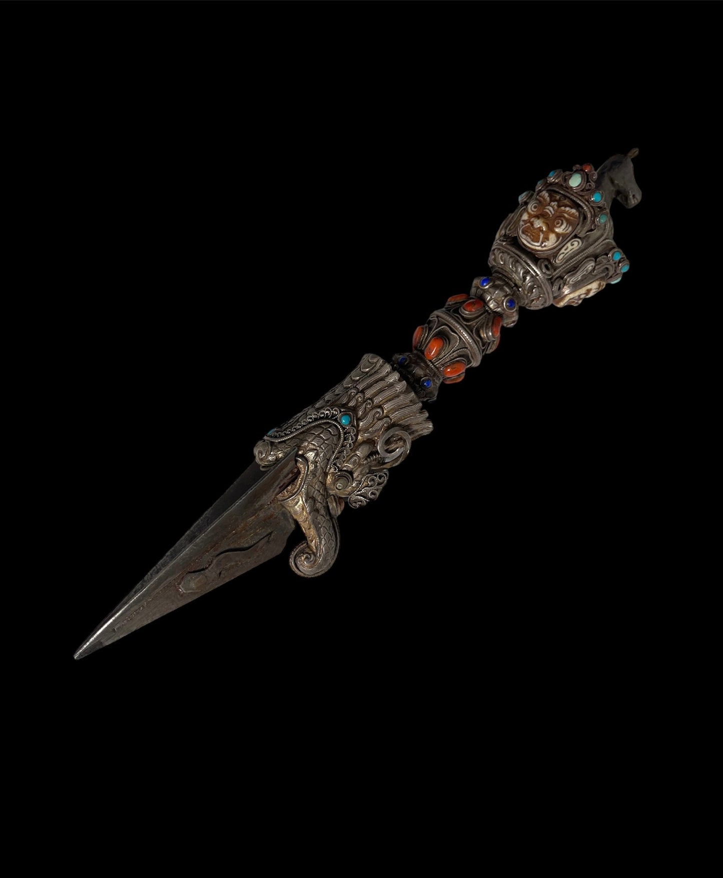 A vintage ceremonial Tibetan dagger in silver and precious stones