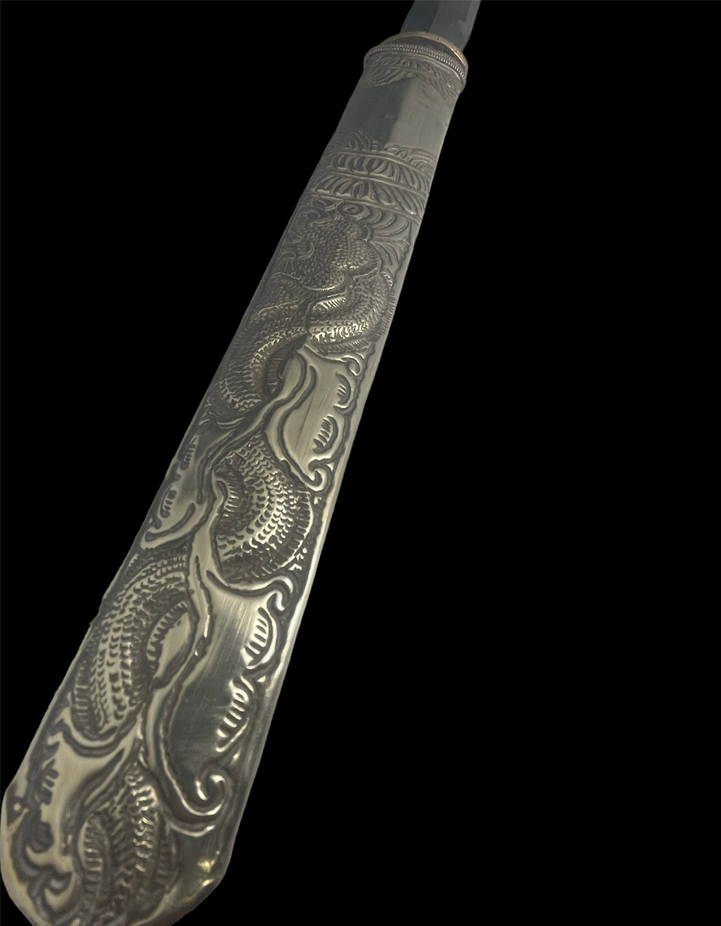 An antique Tibetan dagger with a carved silver sheath