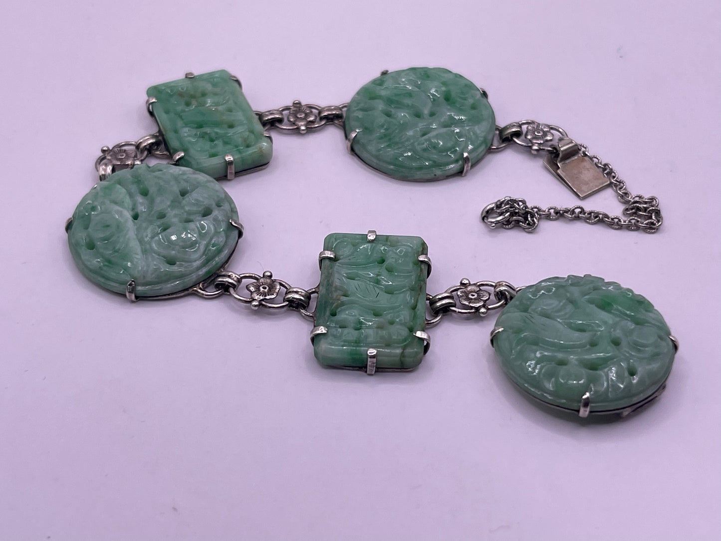 A silver bracelet with jade plaques