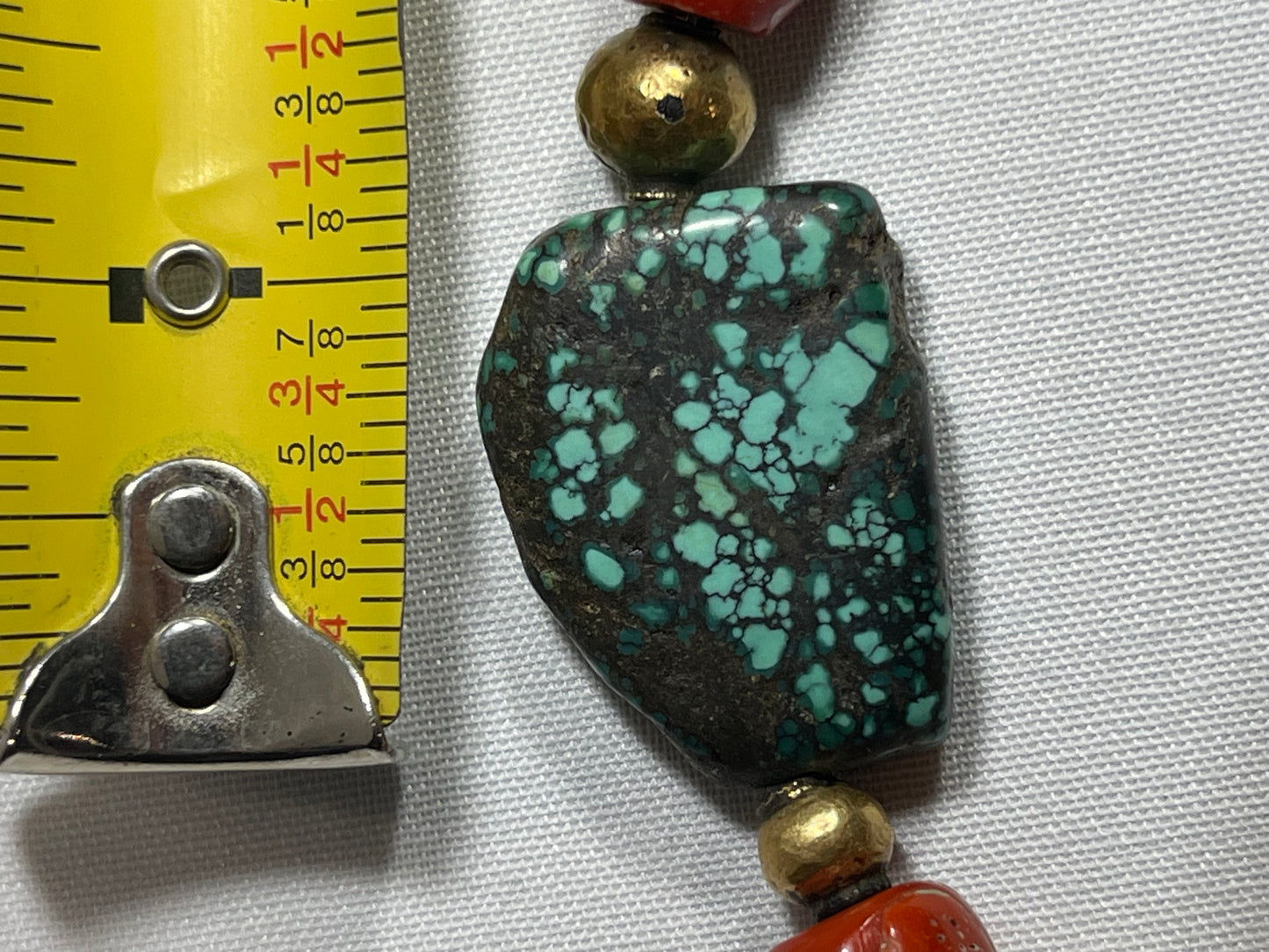 A necklace with antique Tibetan turquoise beads, coral beads and gold beads