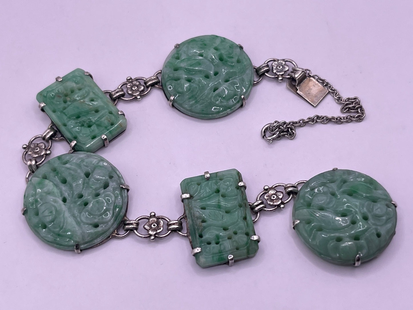 A silver bracelet with jade plaques