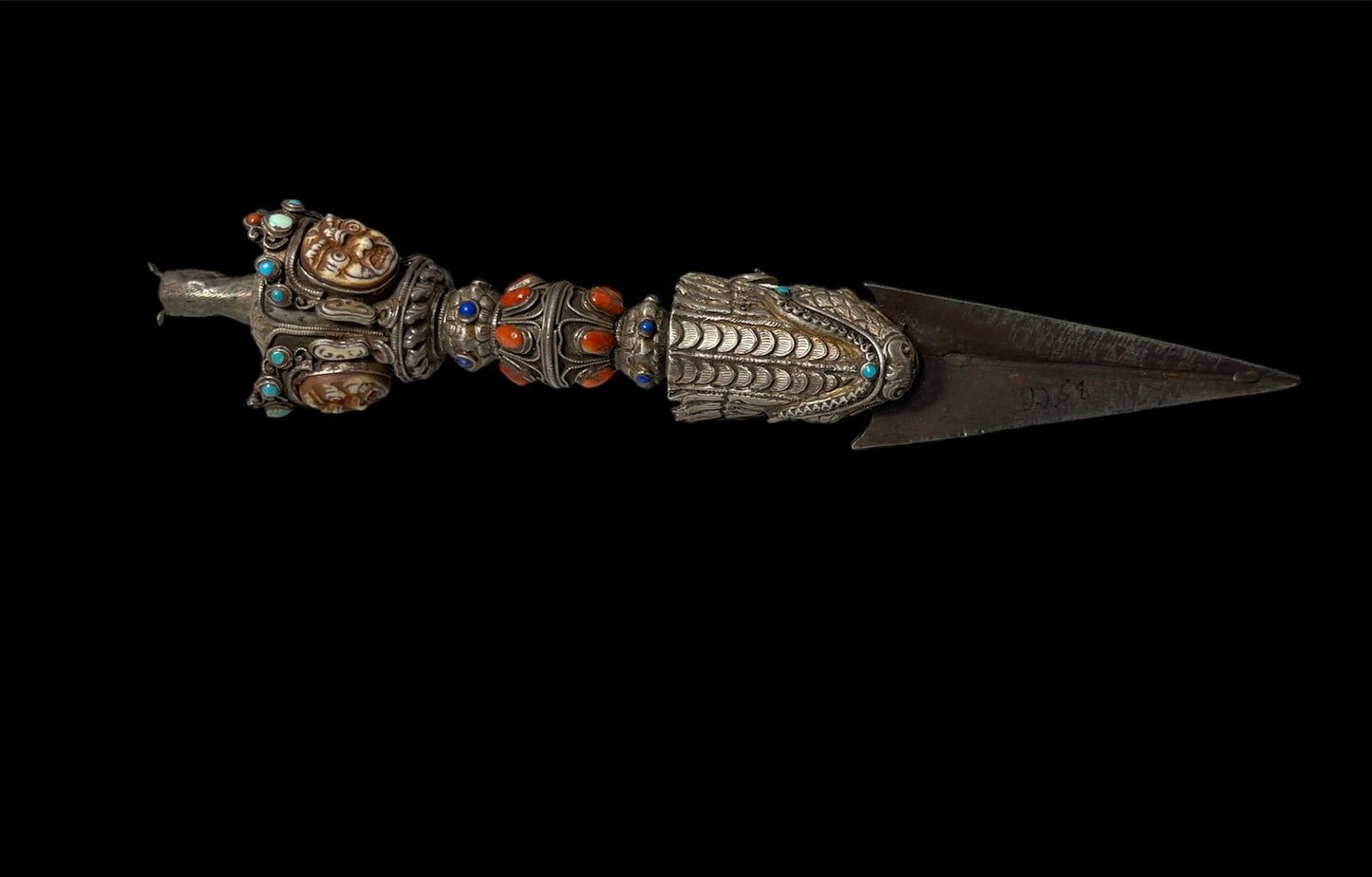 A vintage ceremonial Tibetan dagger in silver and precious stones
