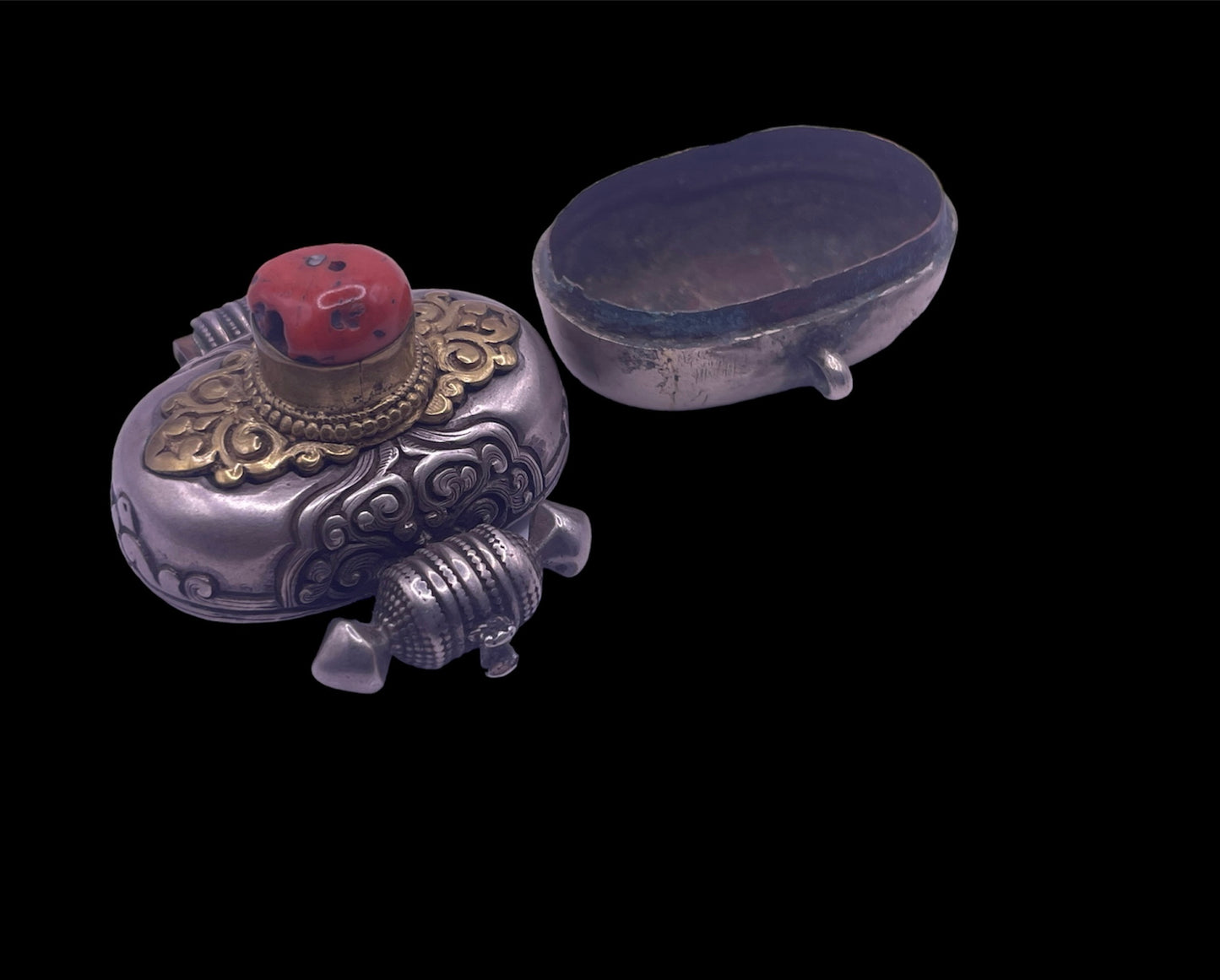 An antique silver and coral ghau amulet
