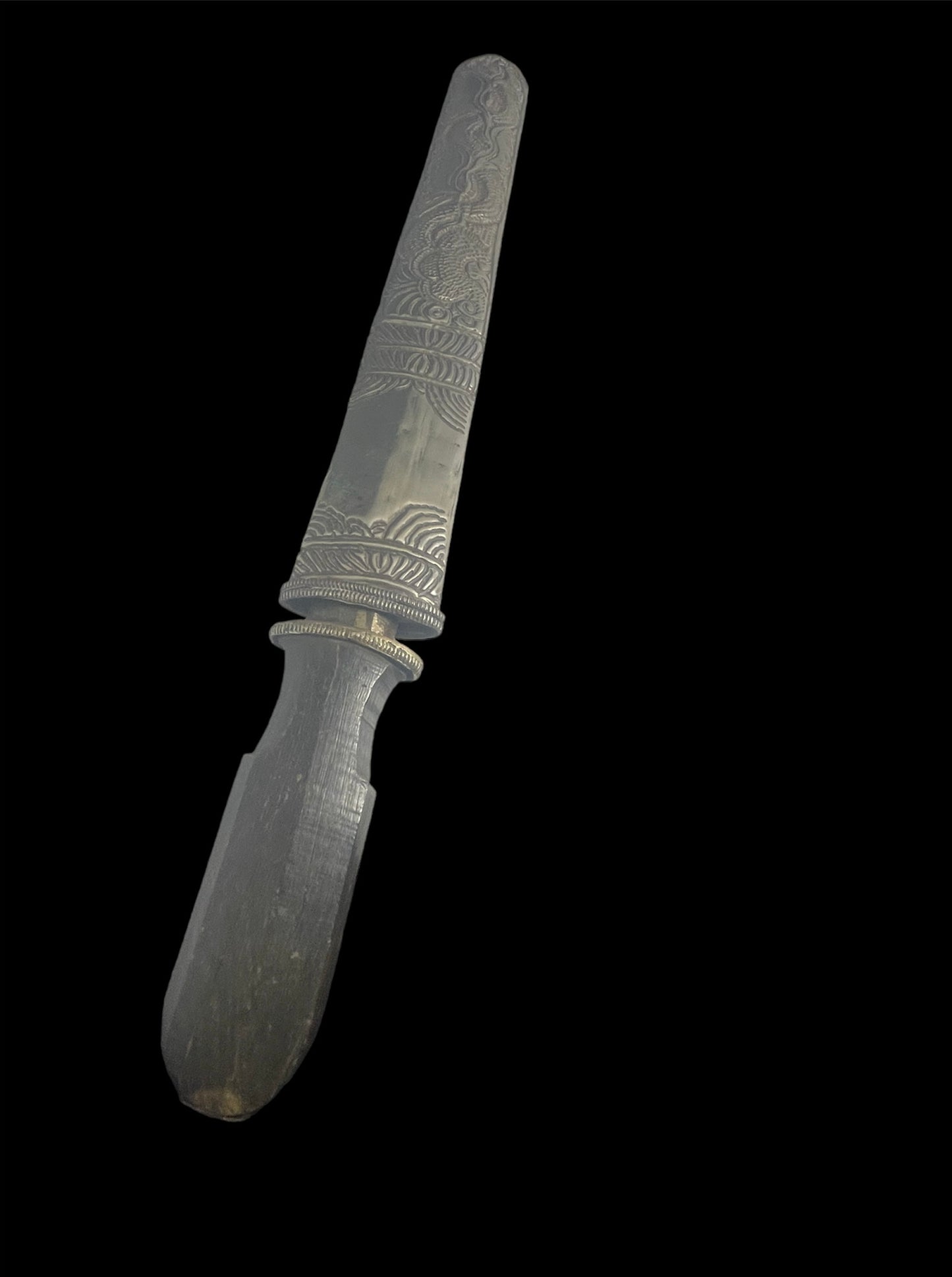 An antique Tibetan dagger with a carved silver sheath