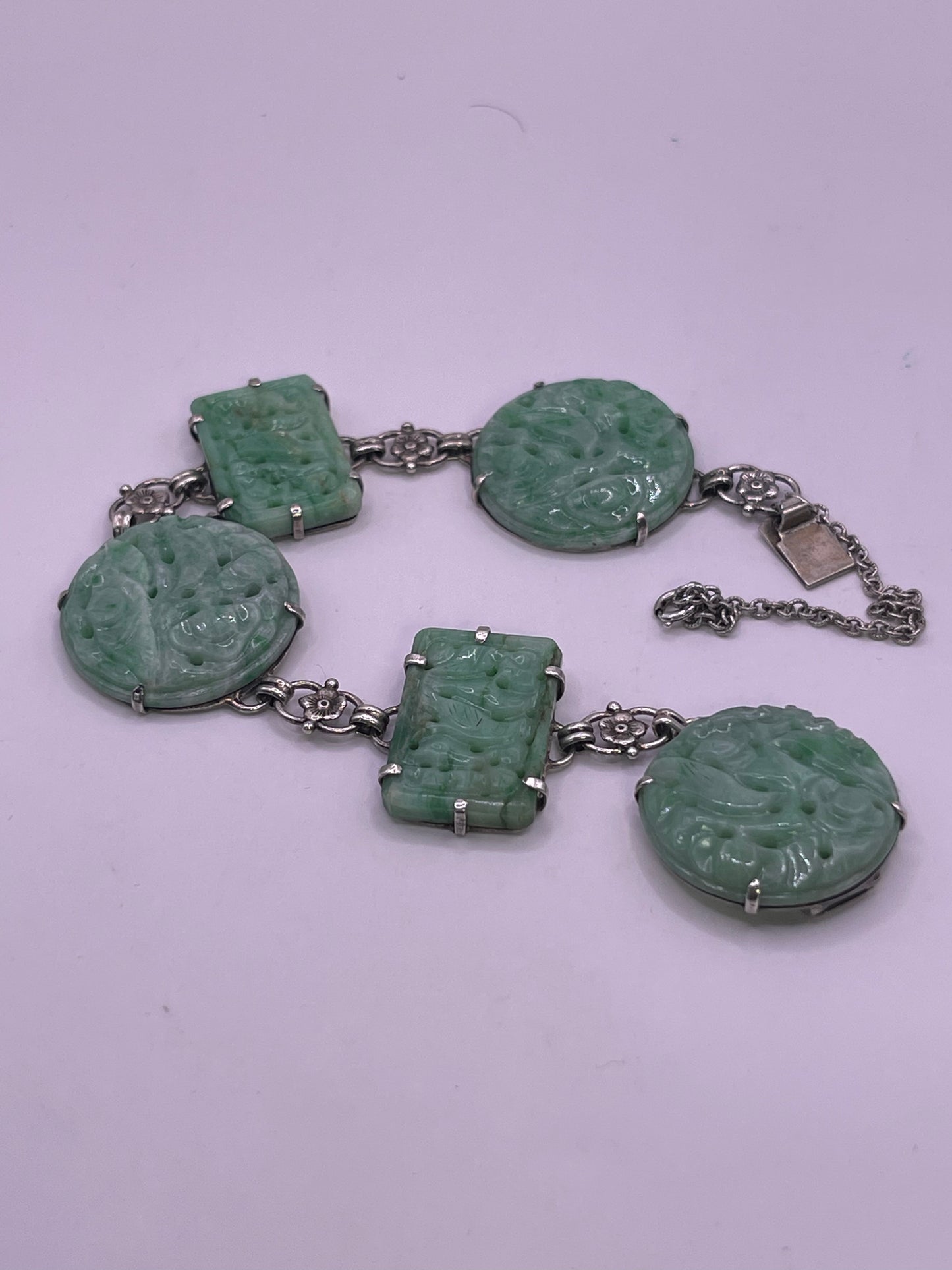 A silver bracelet with jade plaques