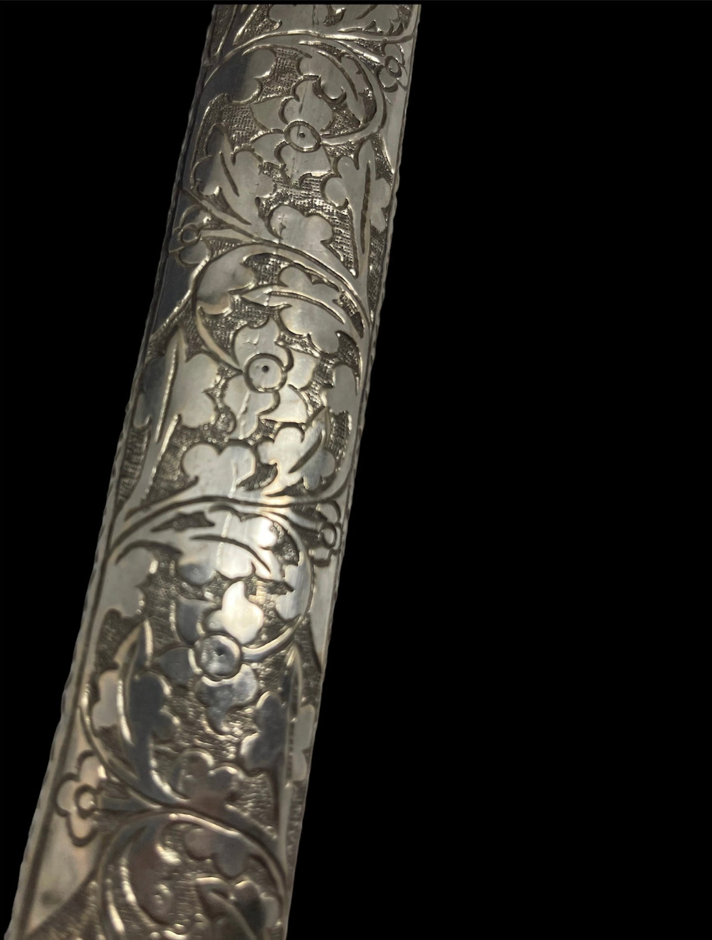 An antique Tibetan dagger with a carved silver sheath