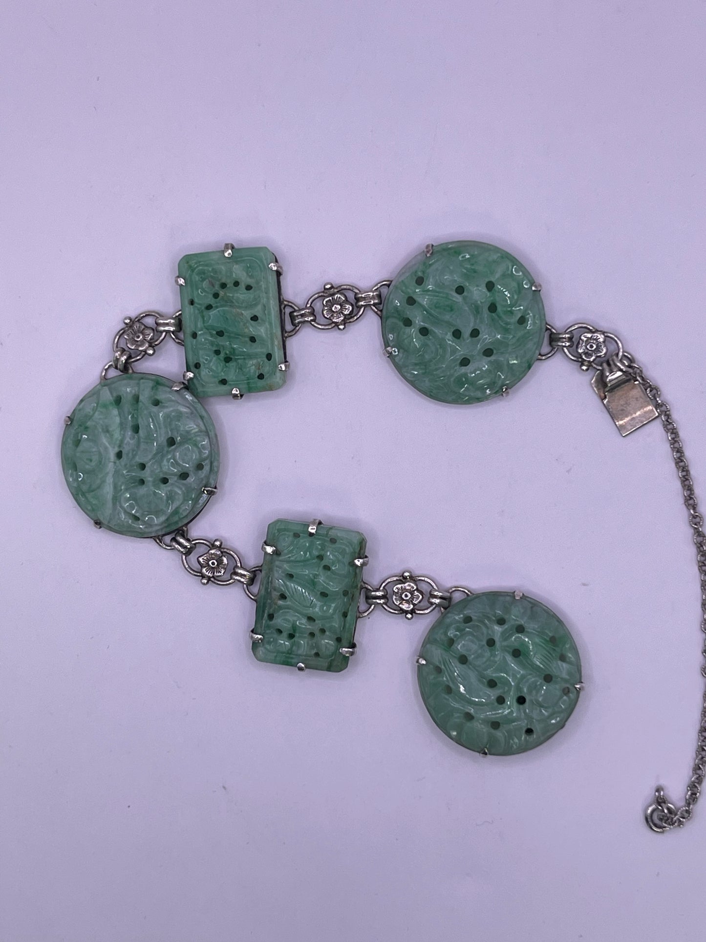 A silver bracelet with jade plaques