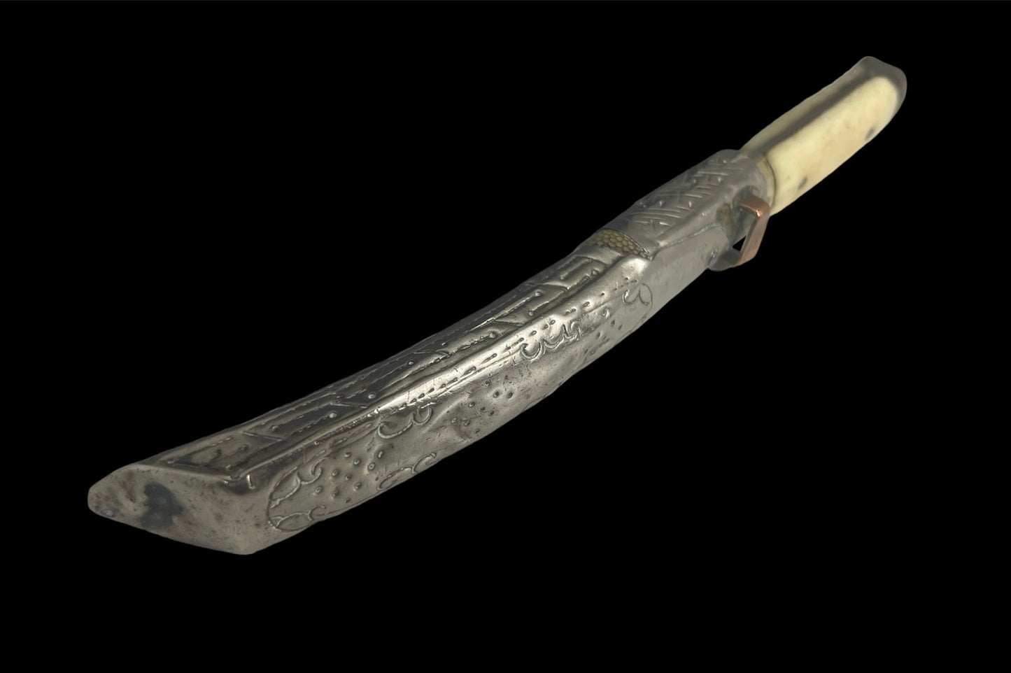 An antique Tibetan dagger with a carved silver sheath