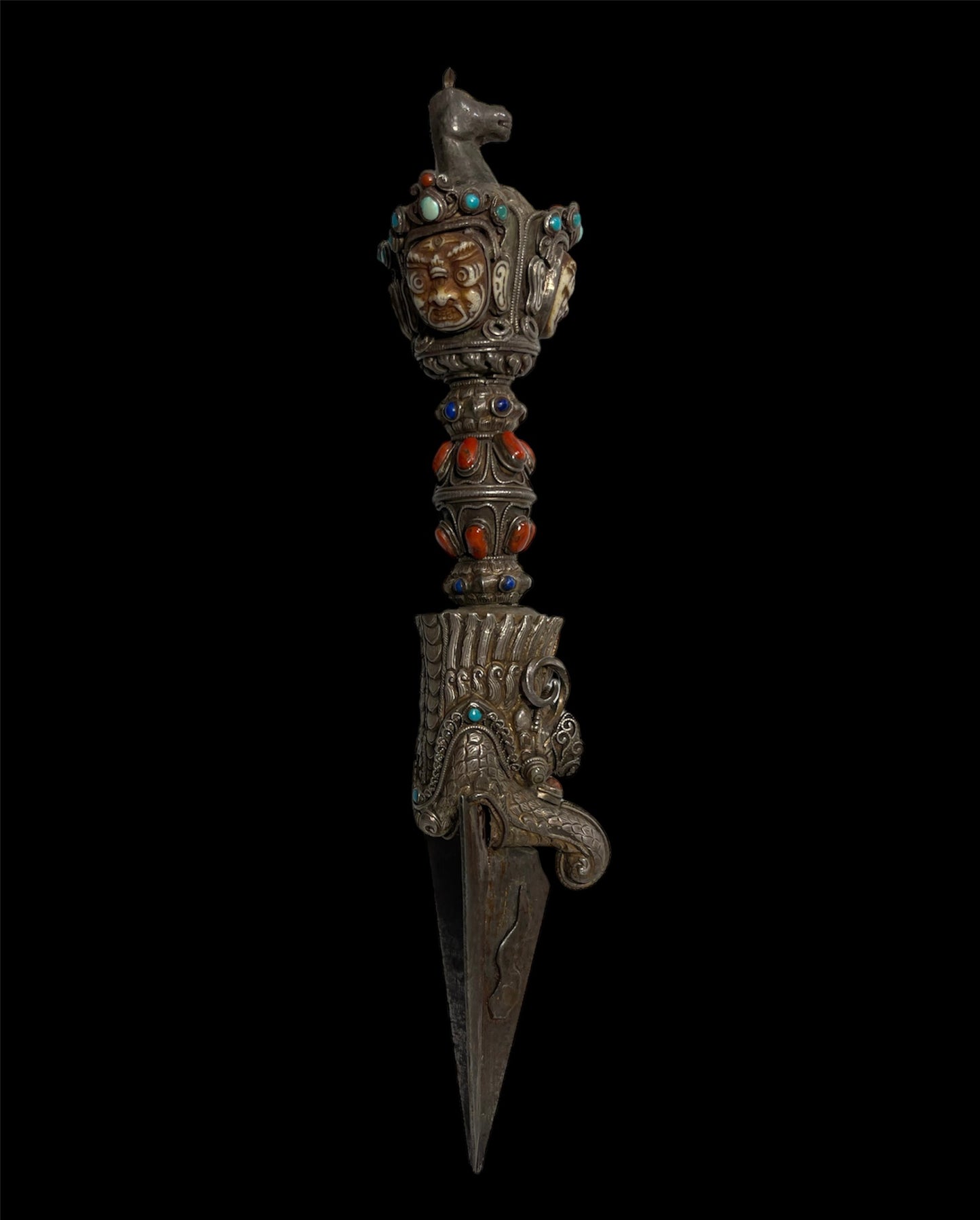 A vintage ceremonial Tibetan dagger in silver and precious stones