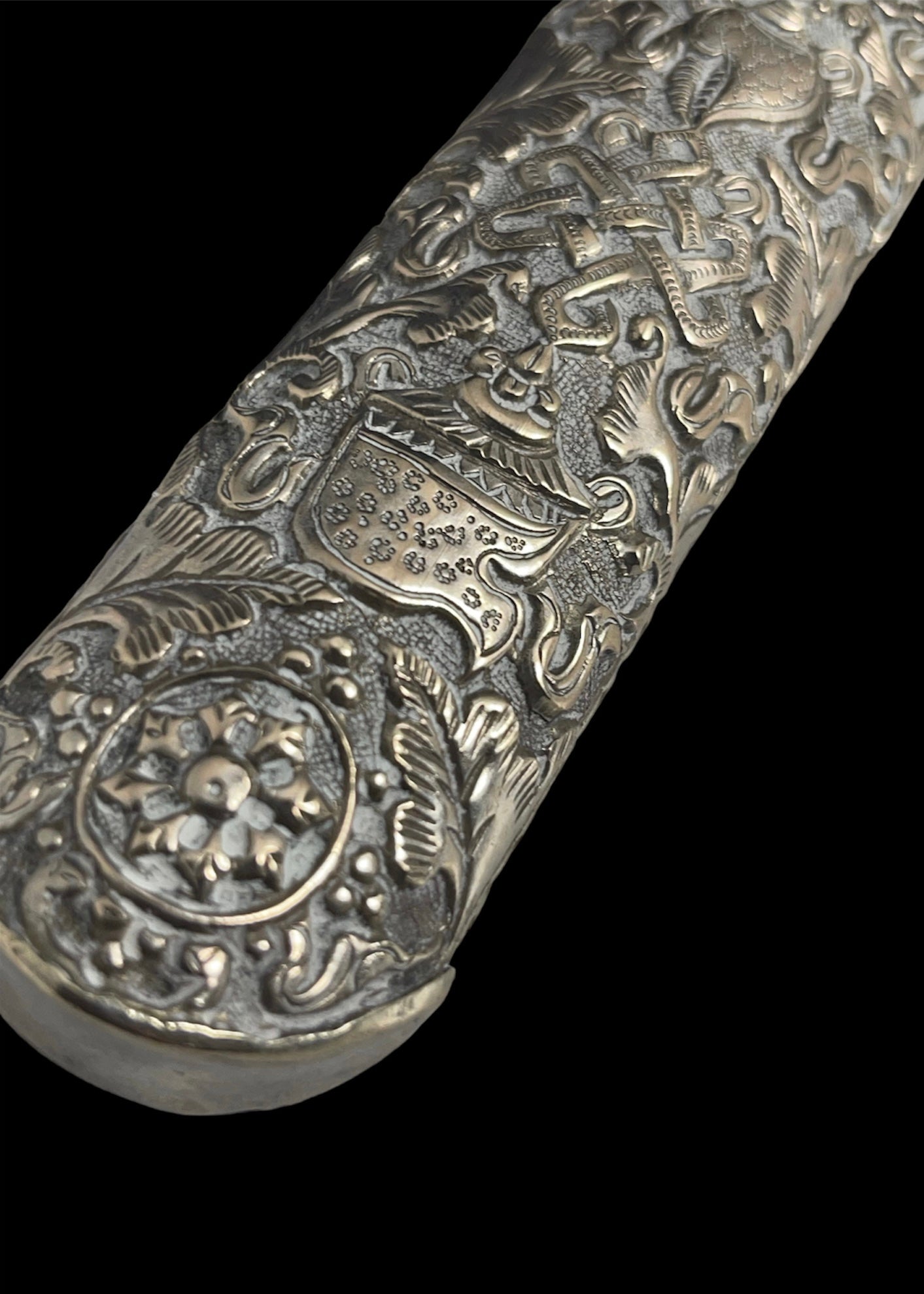 An antique Tibetan dagger with a carved silver sheath