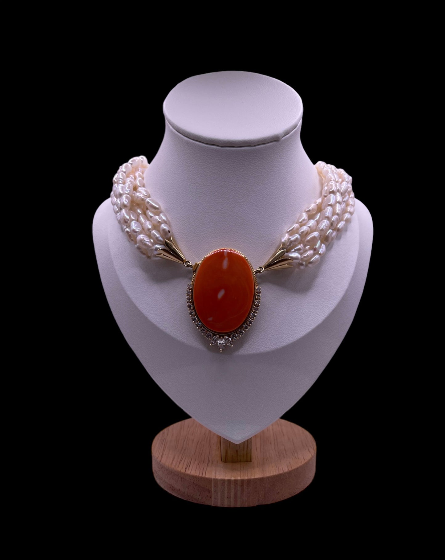 A pearl torsade with coral clasp