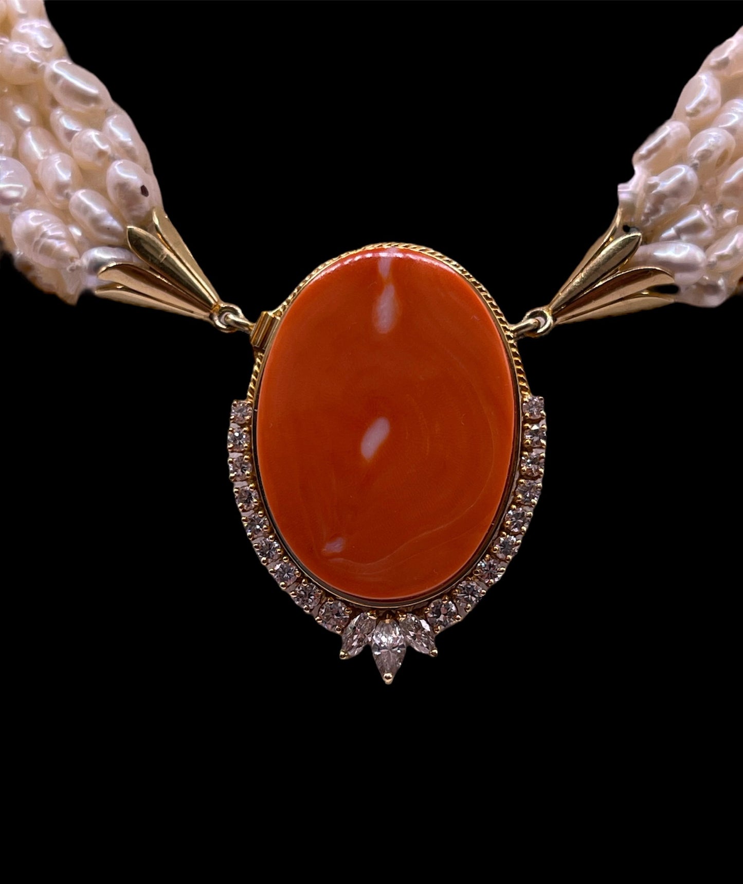 A pearl torsade with coral clasp