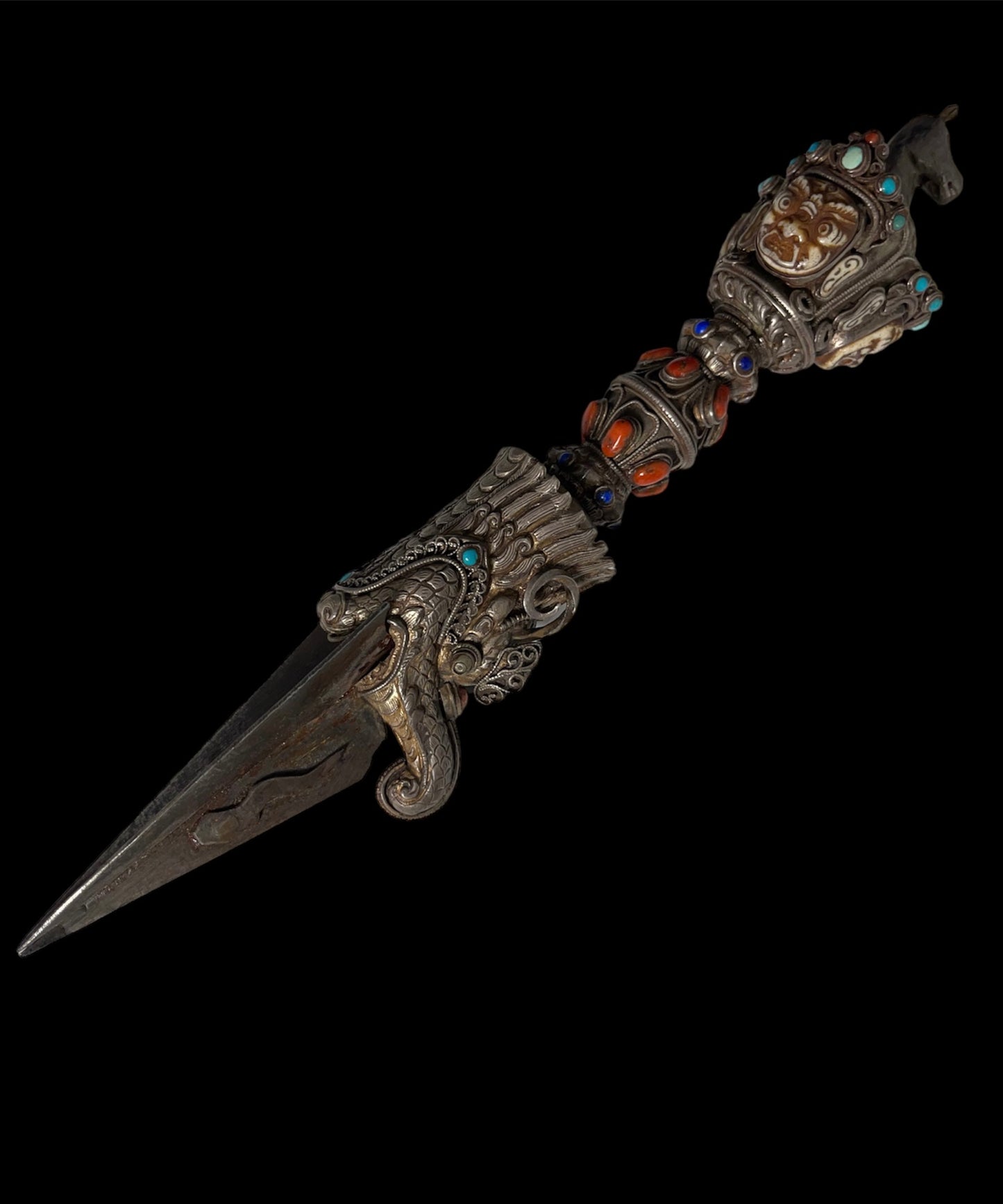 A vintage ceremonial Tibetan dagger in silver and precious stones
