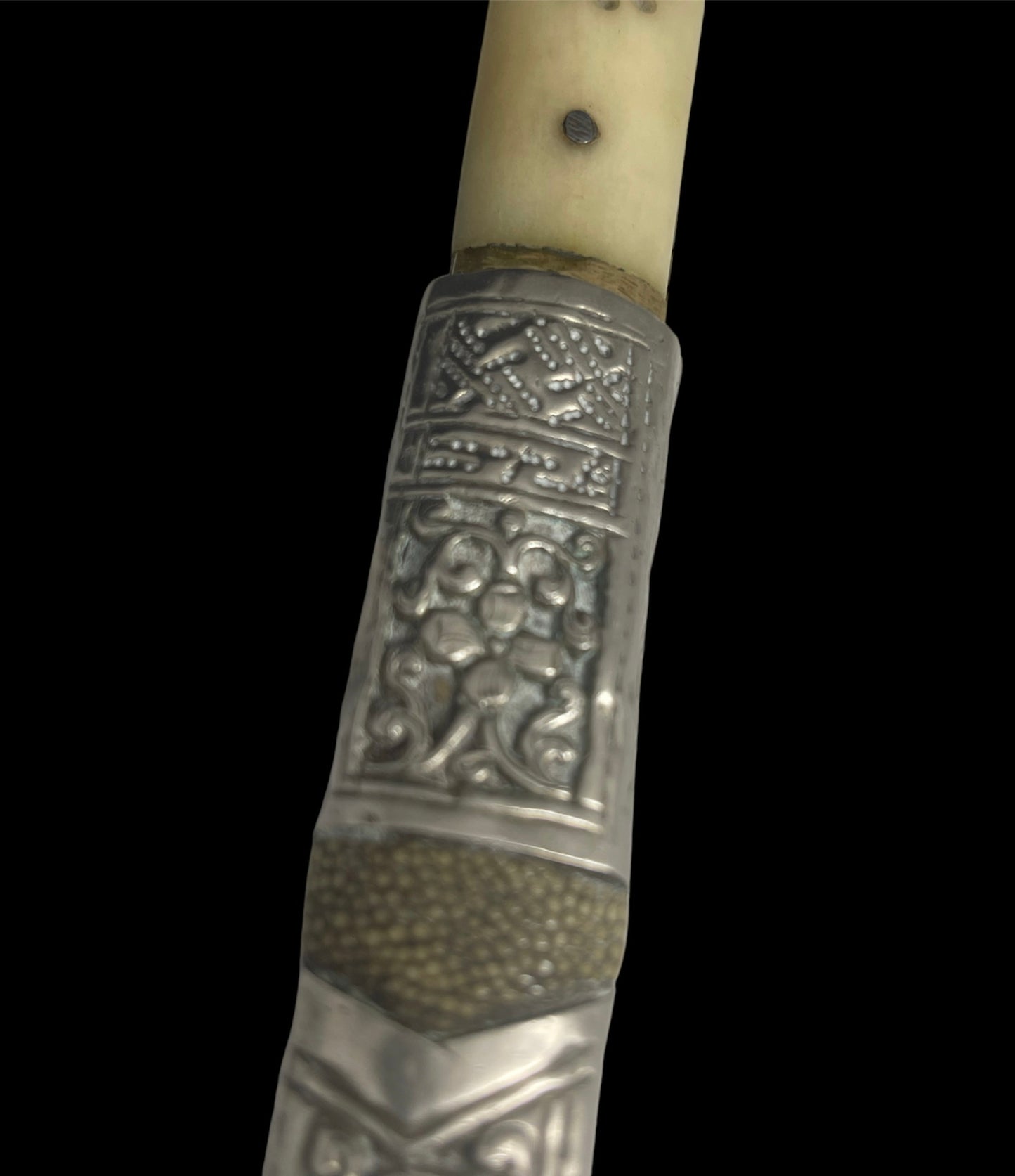 An antique Tibetan dagger with a carved silver sheath