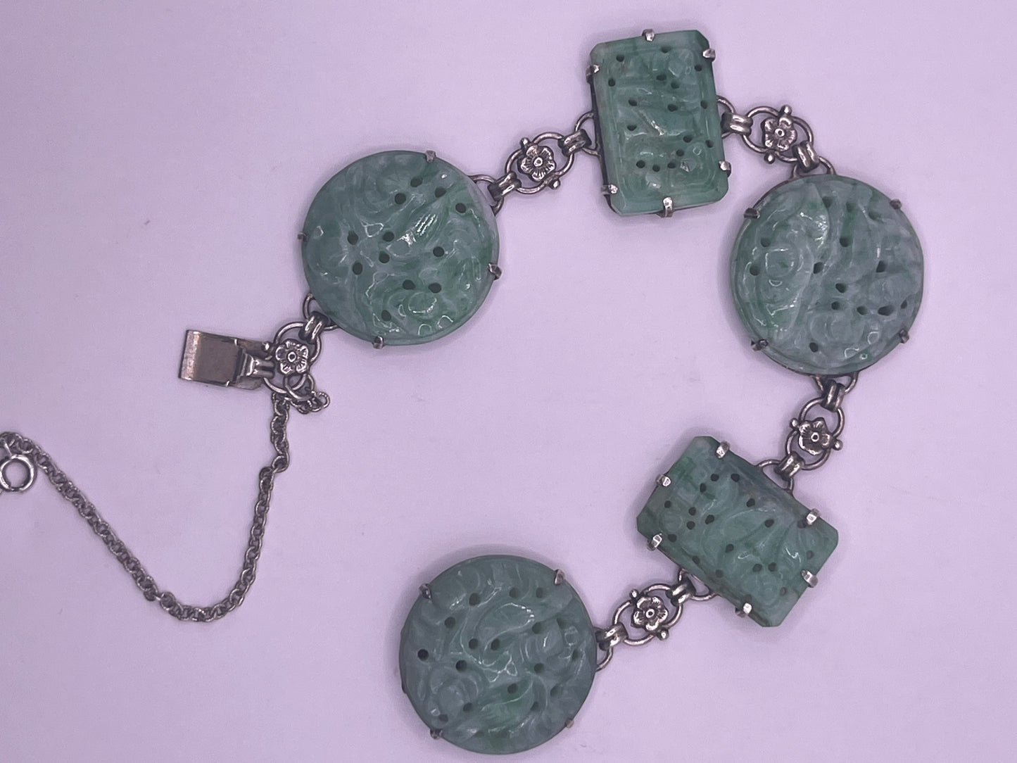 A silver bracelet with jade plaques
