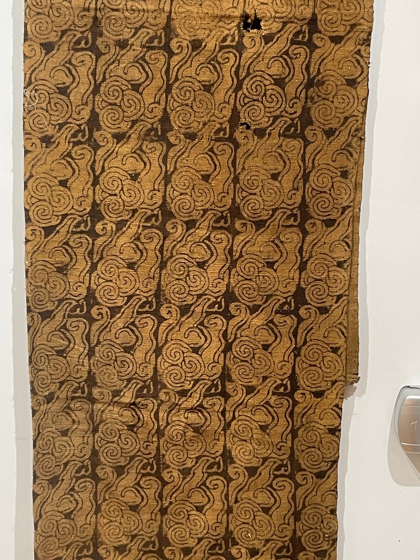 An antique woven and dyed fabric with block print pattern