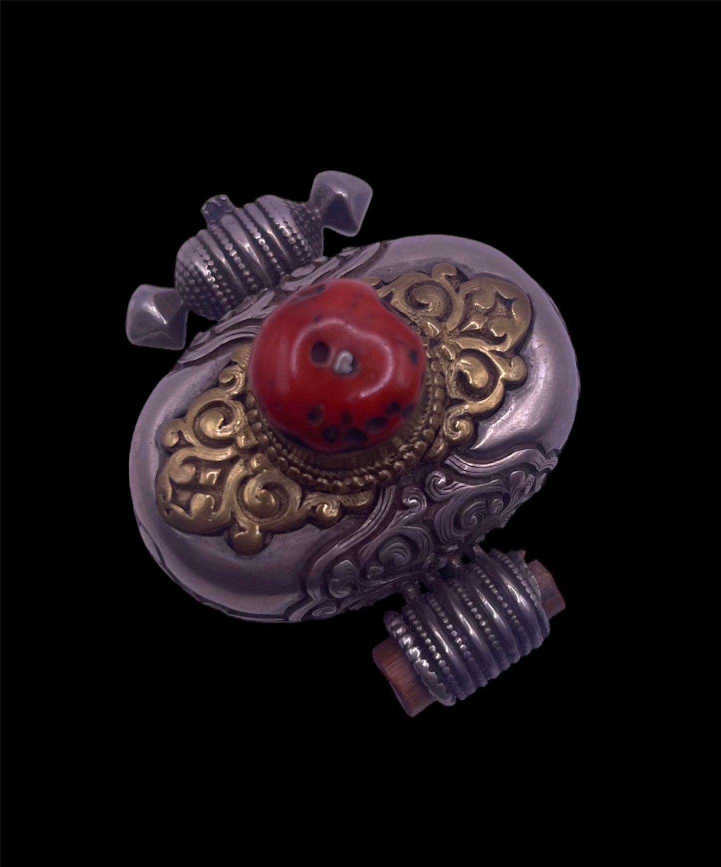 An antique silver and coral ghau amulet